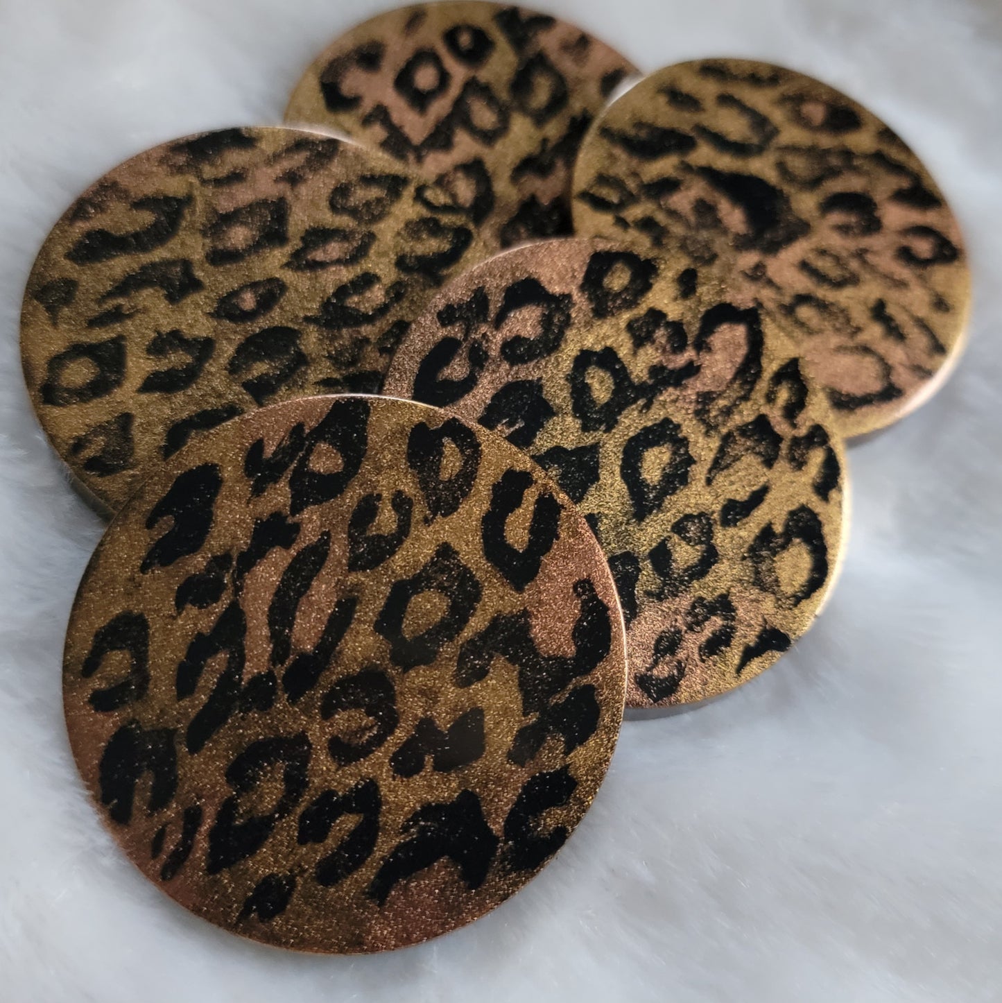 Five round epoxy resin pieces with metallic golden leopard print design,