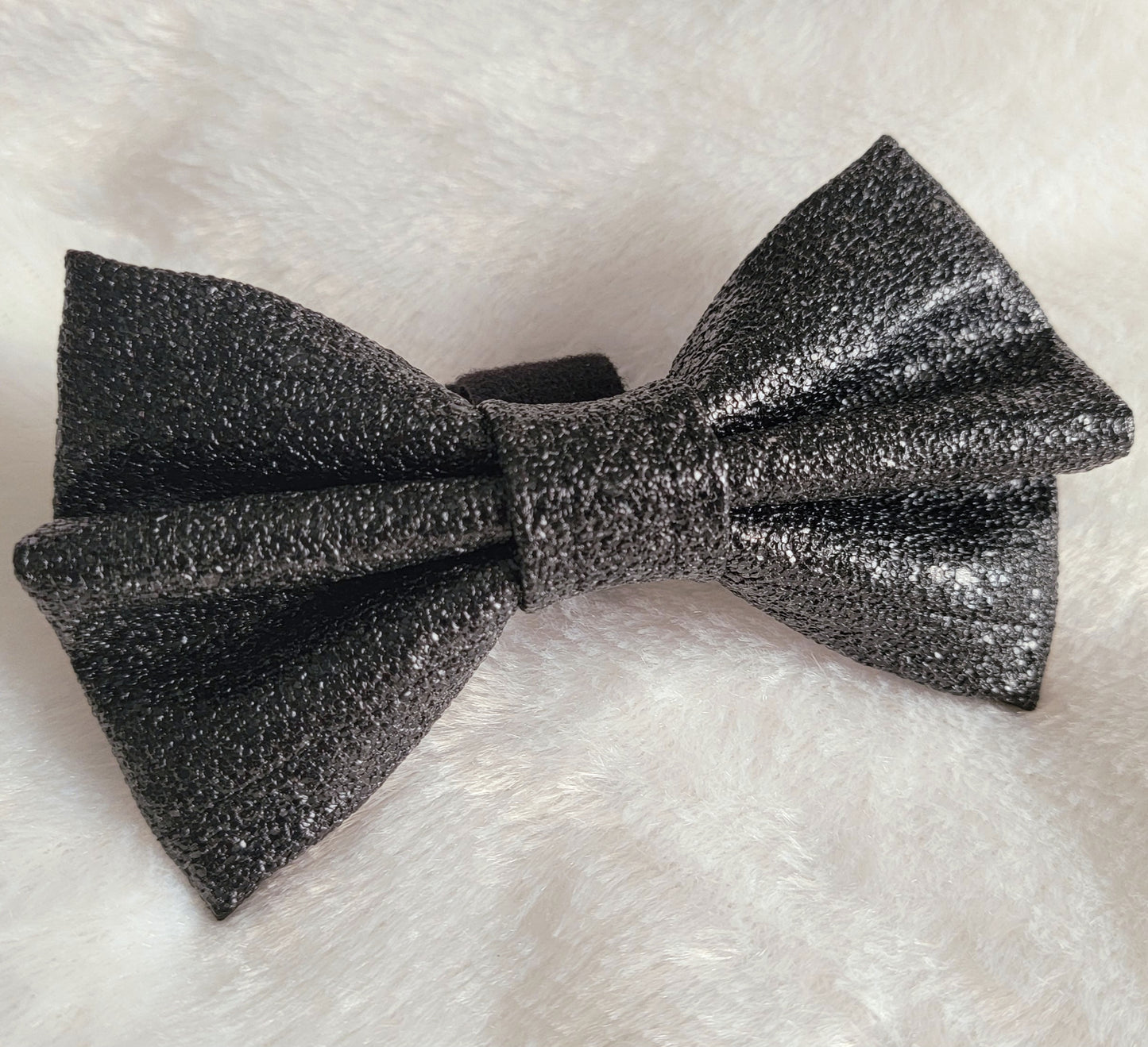 Black faux leather bow with sparkle texture.