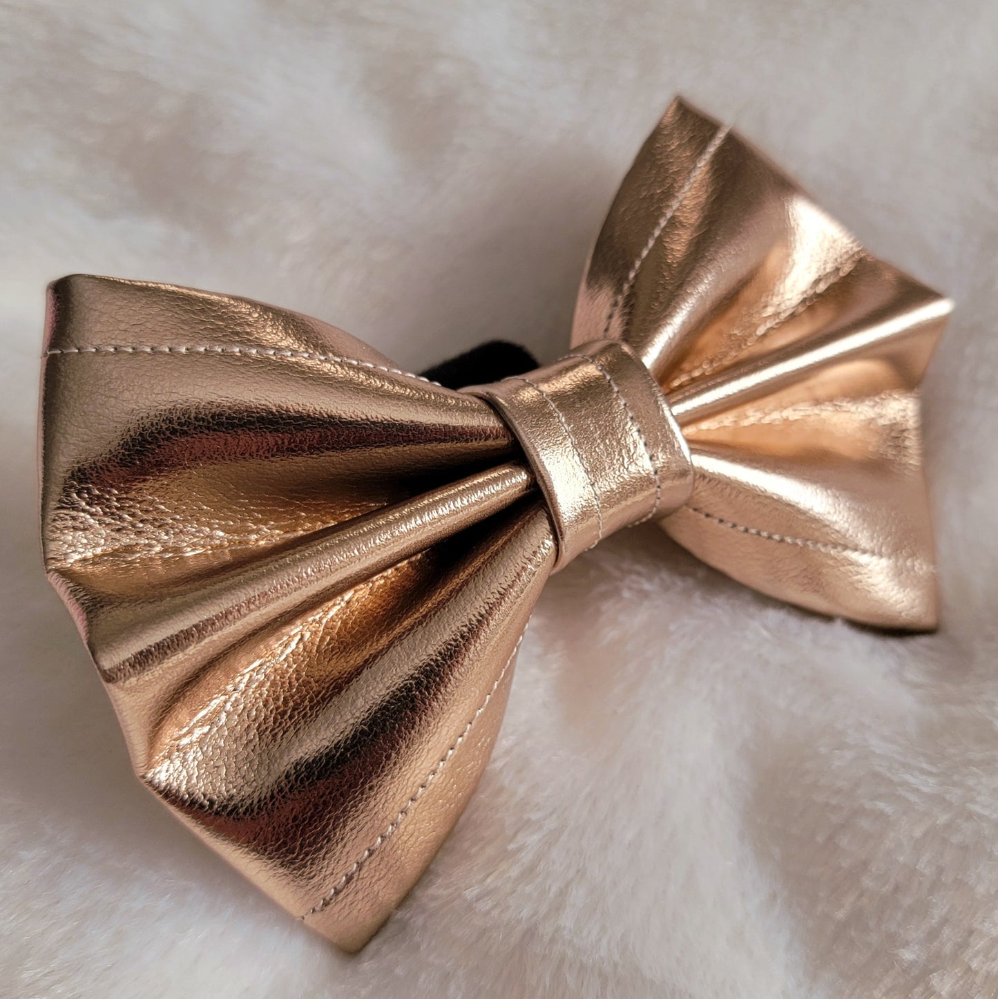 Metallic gold colored faux leather bowtie.