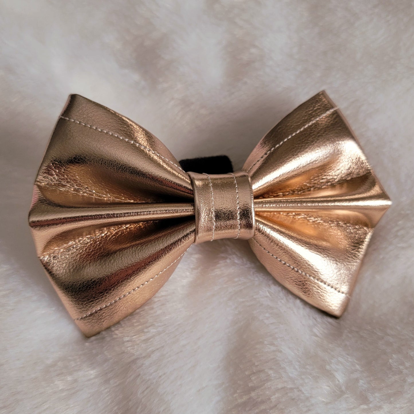 Metallic gold colored faux leather bowtie.