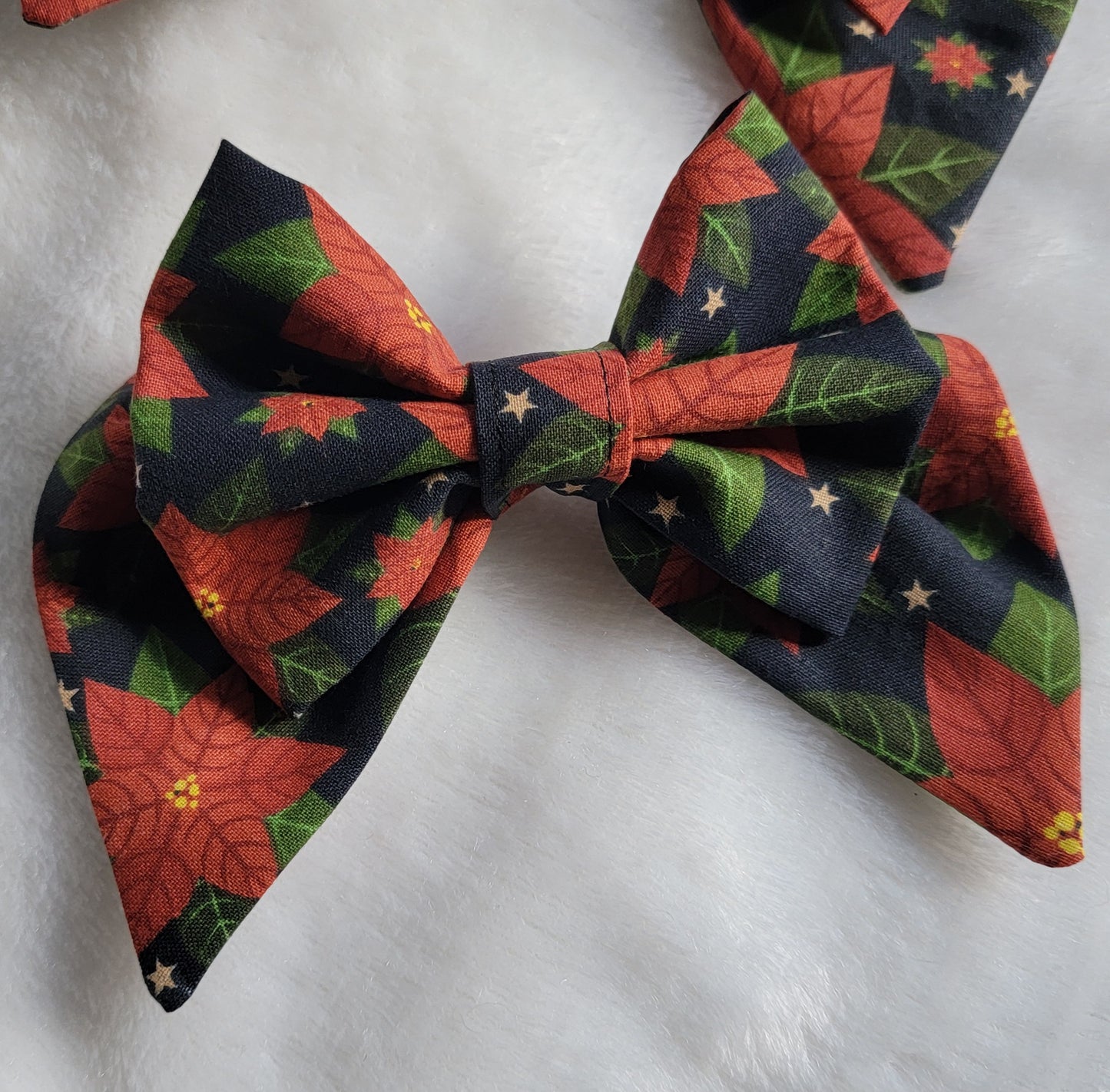 Small sailor bow made with poinsettia print cotton, displayed on a white background.