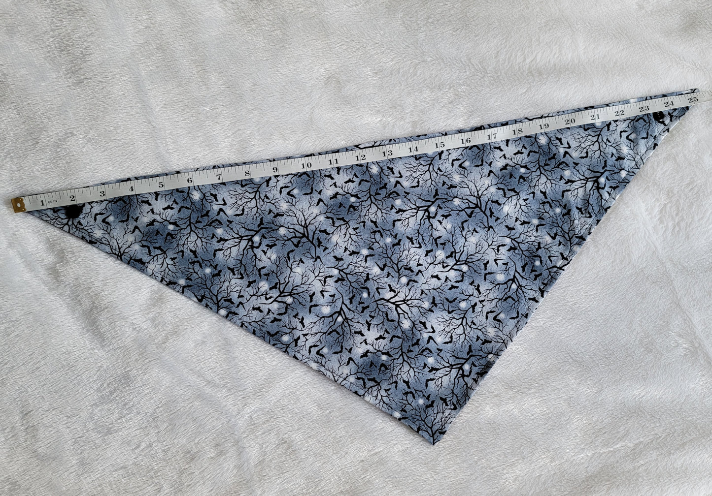 Bandana shown with measuring tape to show large size is 25.5", print is greyscale tree branches and bats.