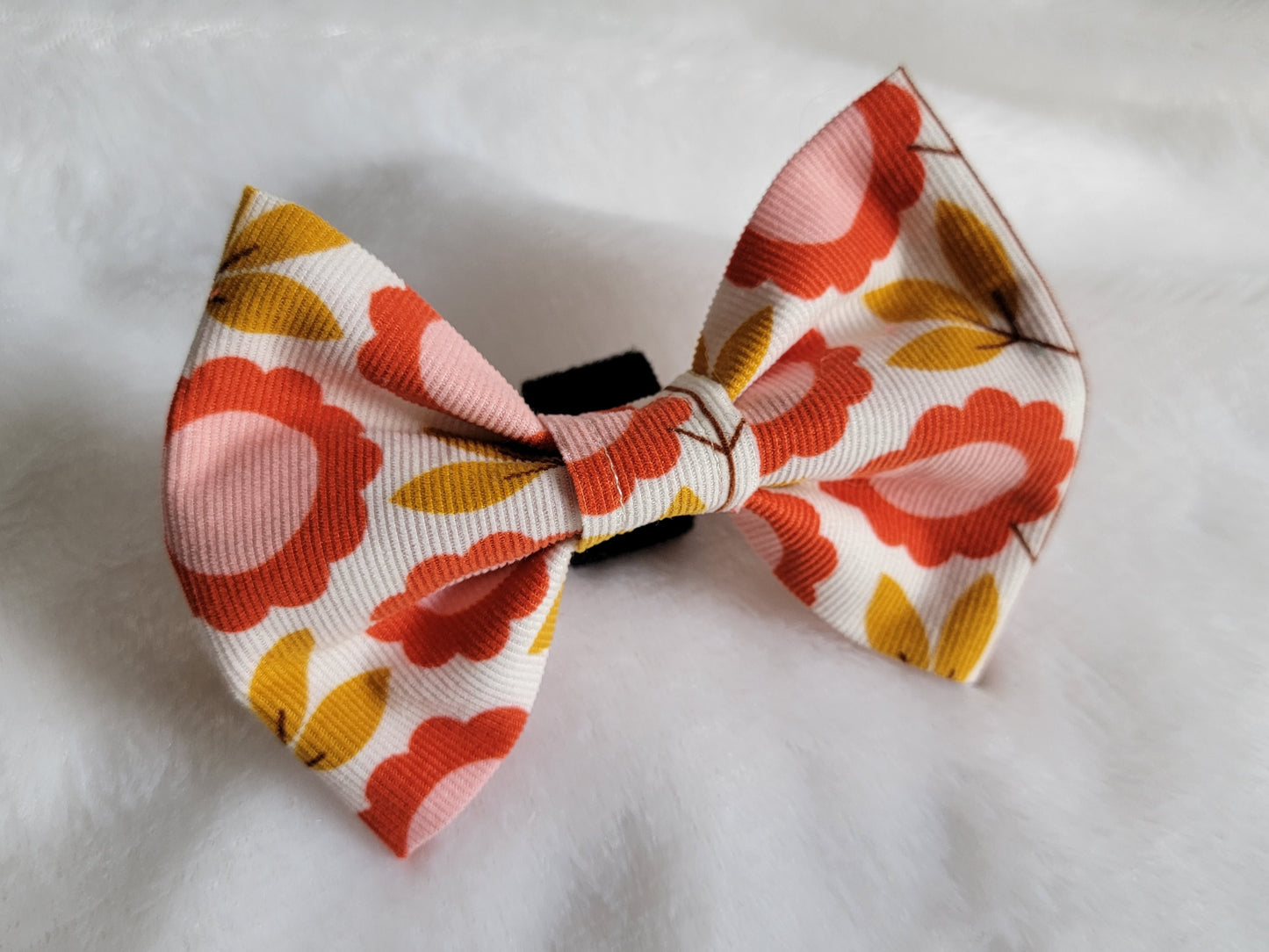Pet bowtie made of cotton corduroy with flower print in rusty reds and golds.
