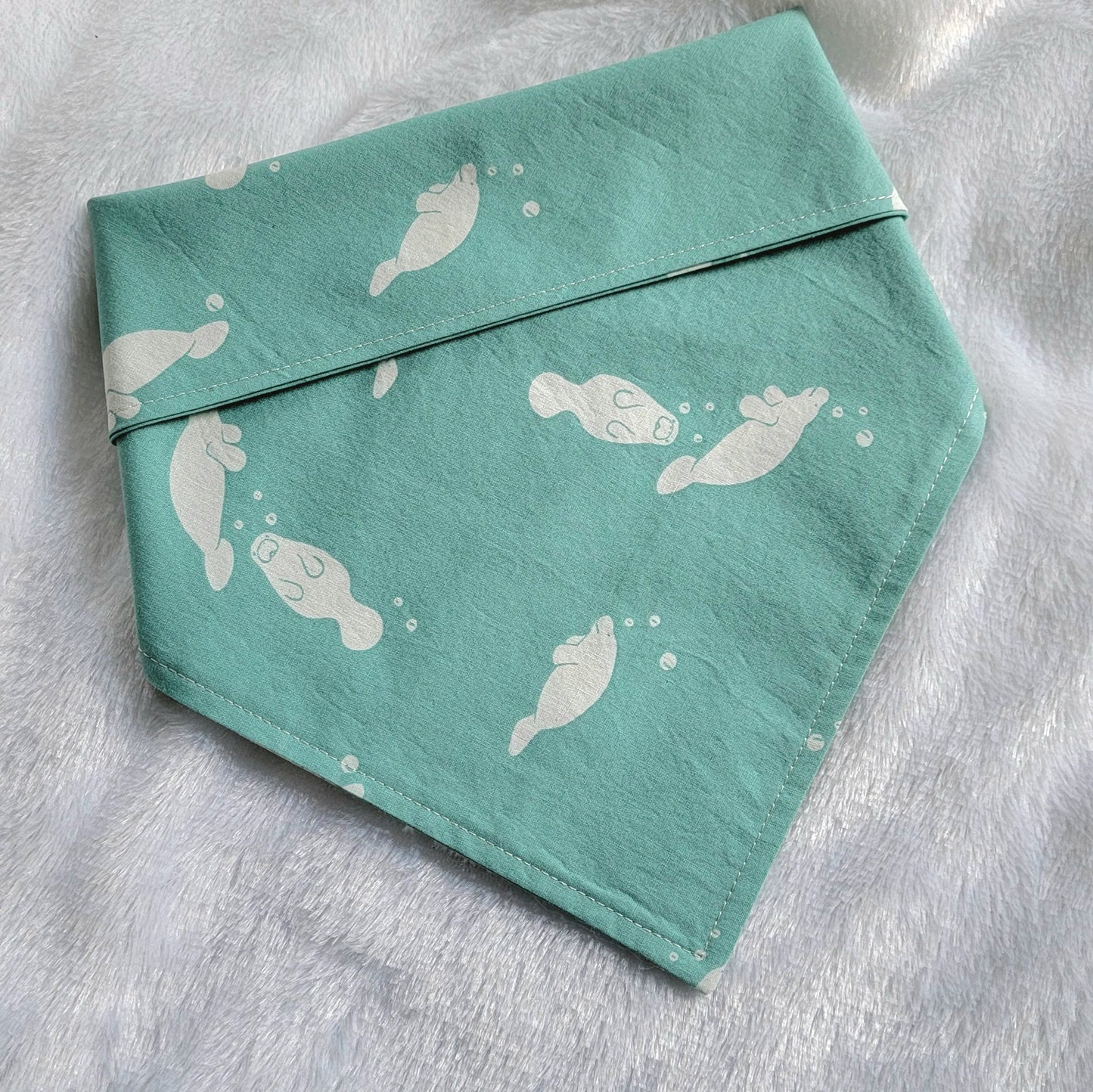 Bandana made with light aqua manatee print cotton.