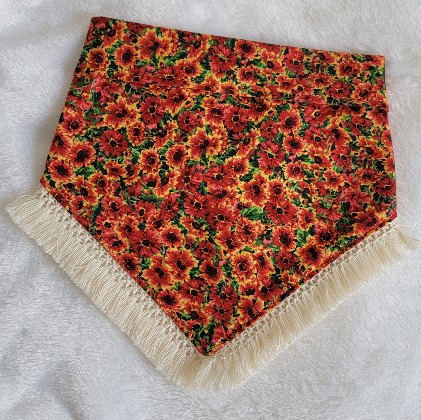 Handmade pet bandana with rich orange floral print and natural cream colored fringe.