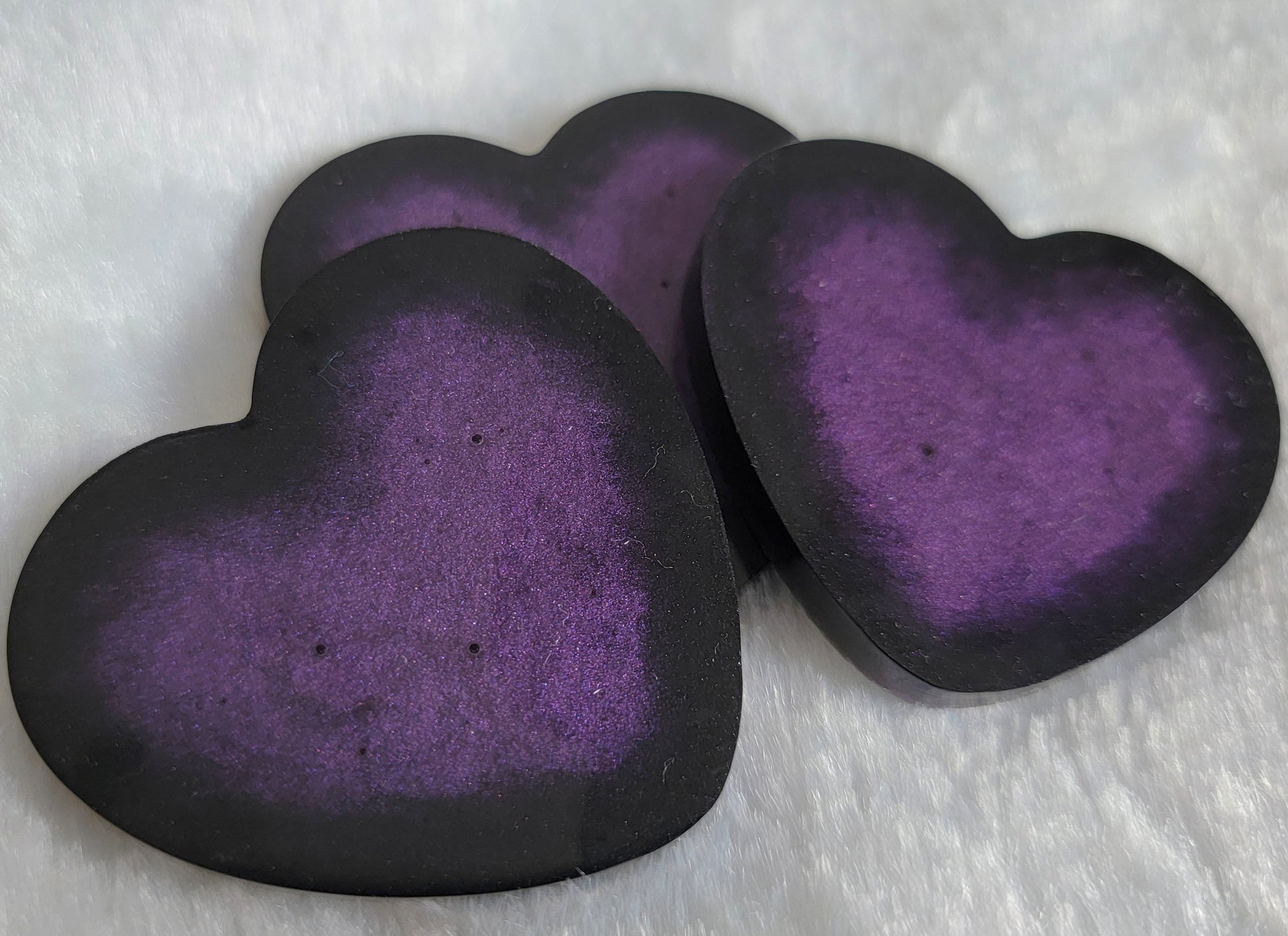 Large heart shaped epoxy resin pieces, deep purple center with sparkly black edges.