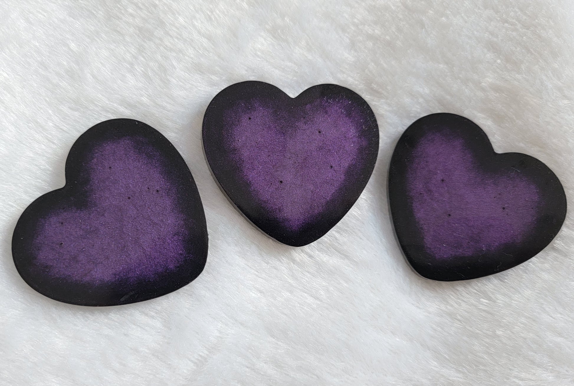 Large heart shaped epoxy resin pieces, deep purple center with sparkly black edges.