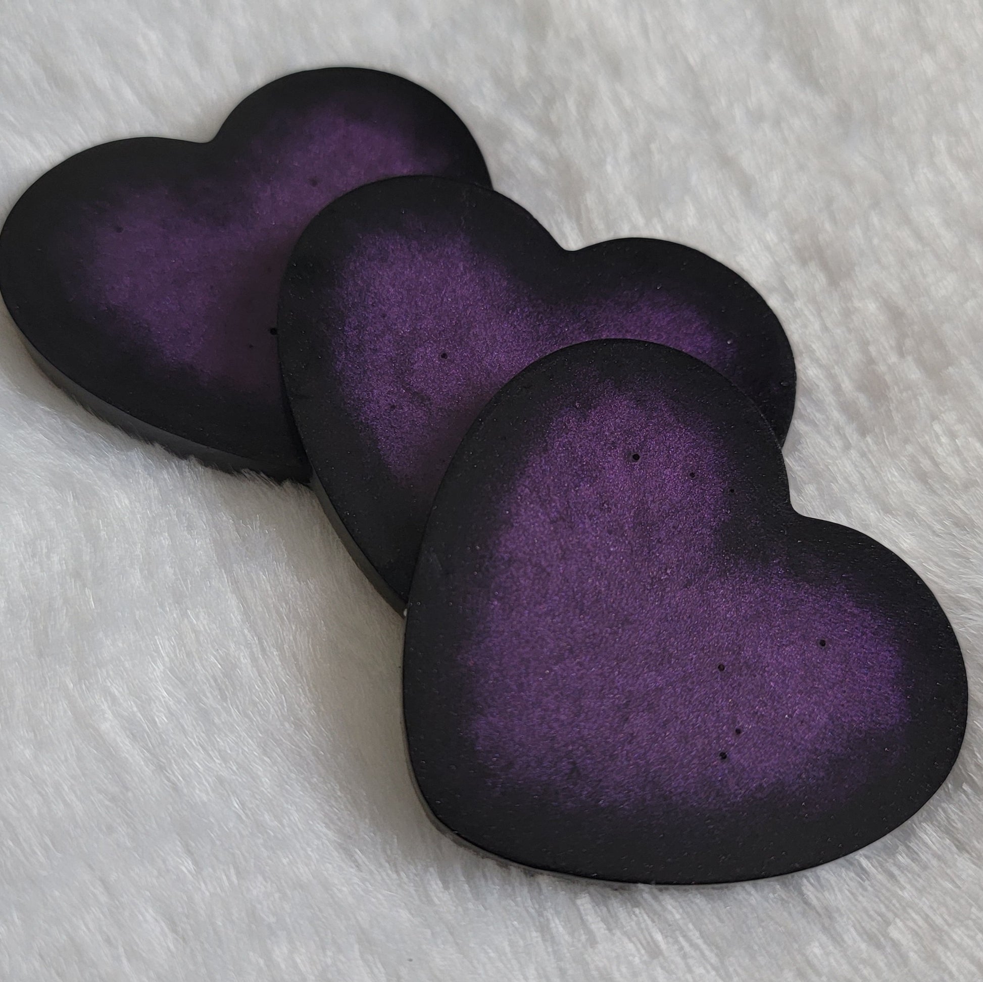 Large heart shaped epoxy resin pieces, deep purple center with sparkly black edges.