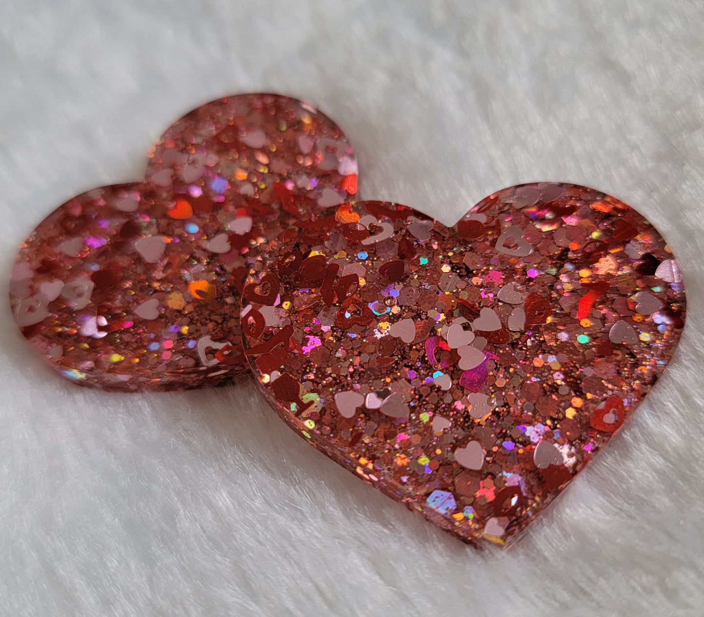 Heart shaped epoxy resin pieces, pink and red holographic valentine's themed glitter.