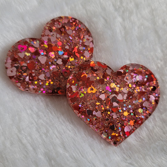 Heart shaped epoxy resin pieces, pink and red holographic valentine's themed glitter.