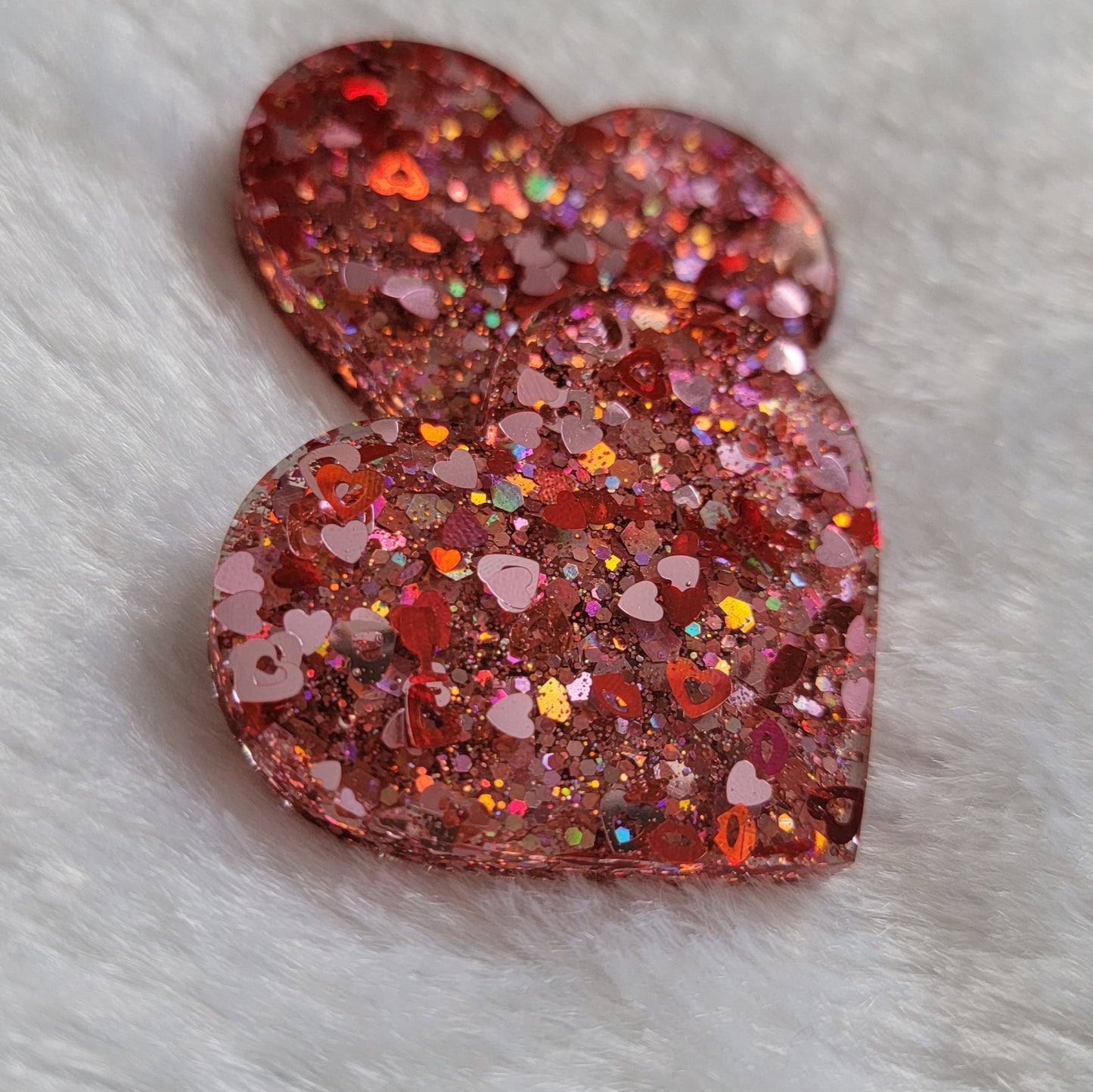 Heart shaped epoxy resin pieces, pink and red holographic valentine's themed glitter.