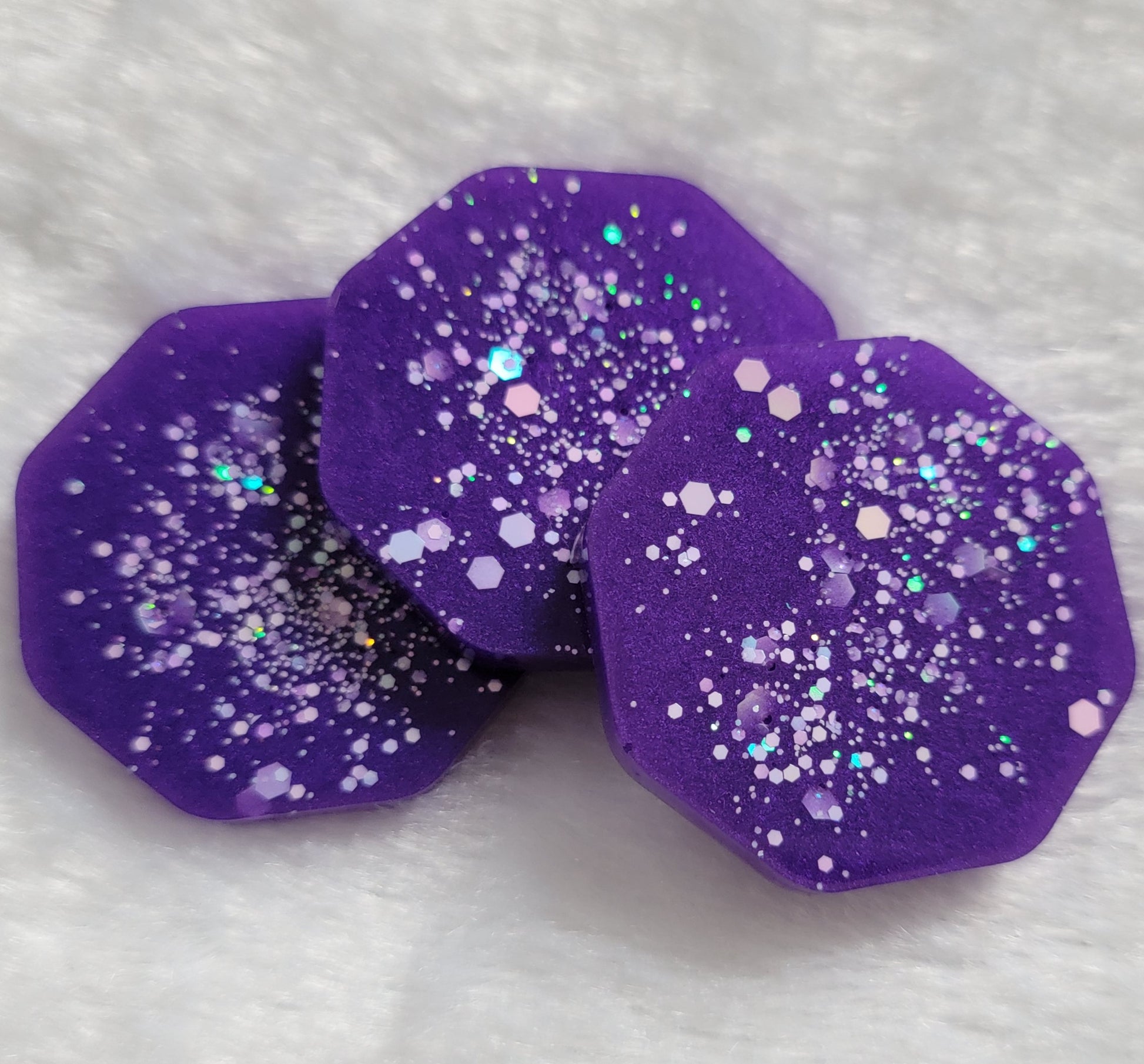 Octagon shaped epoxy resin pieces, bright violet with opal white glitter.