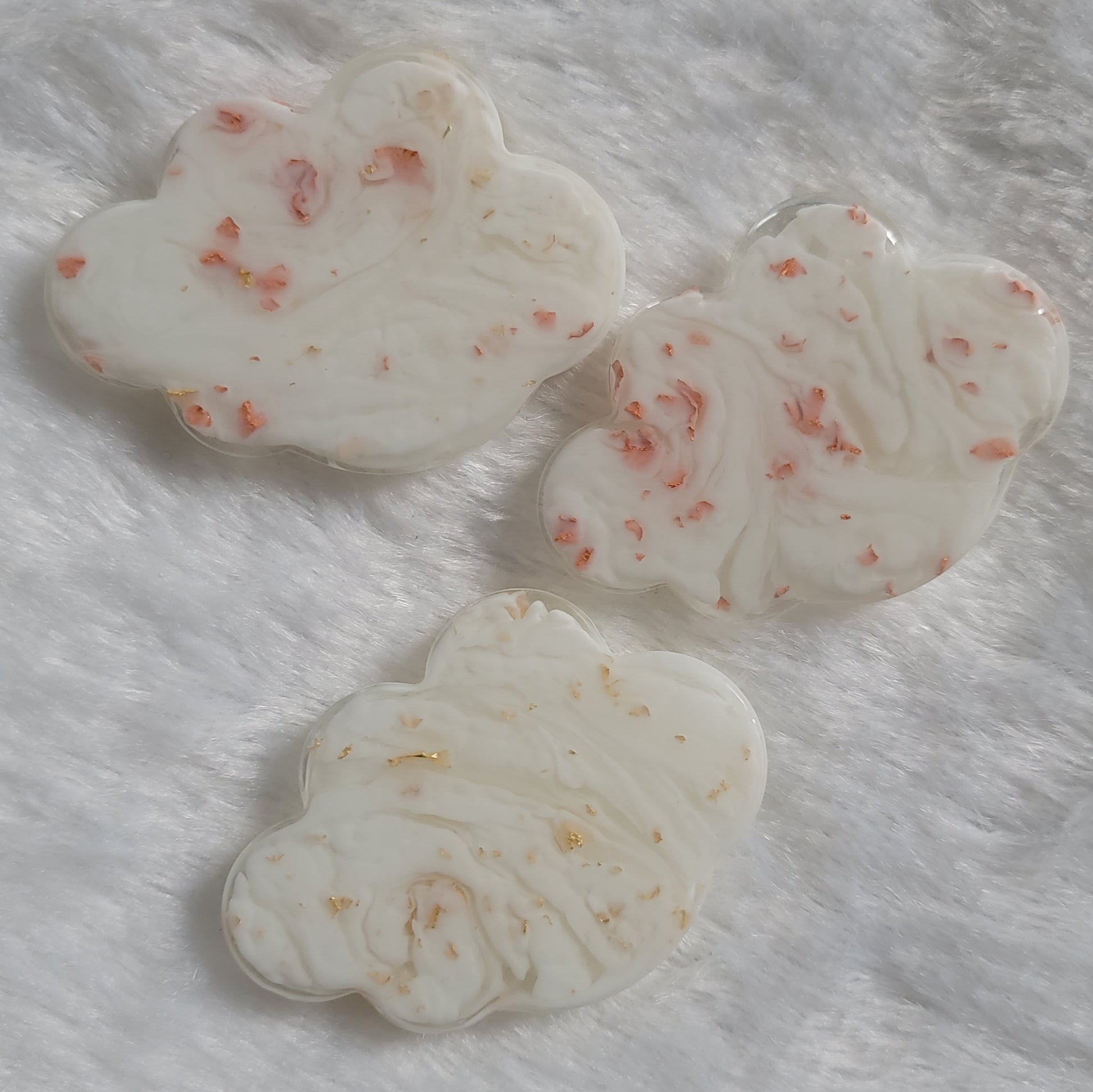 Cloud shaped epoxy resin pieces, white swirls with copper and gold foil flakes.