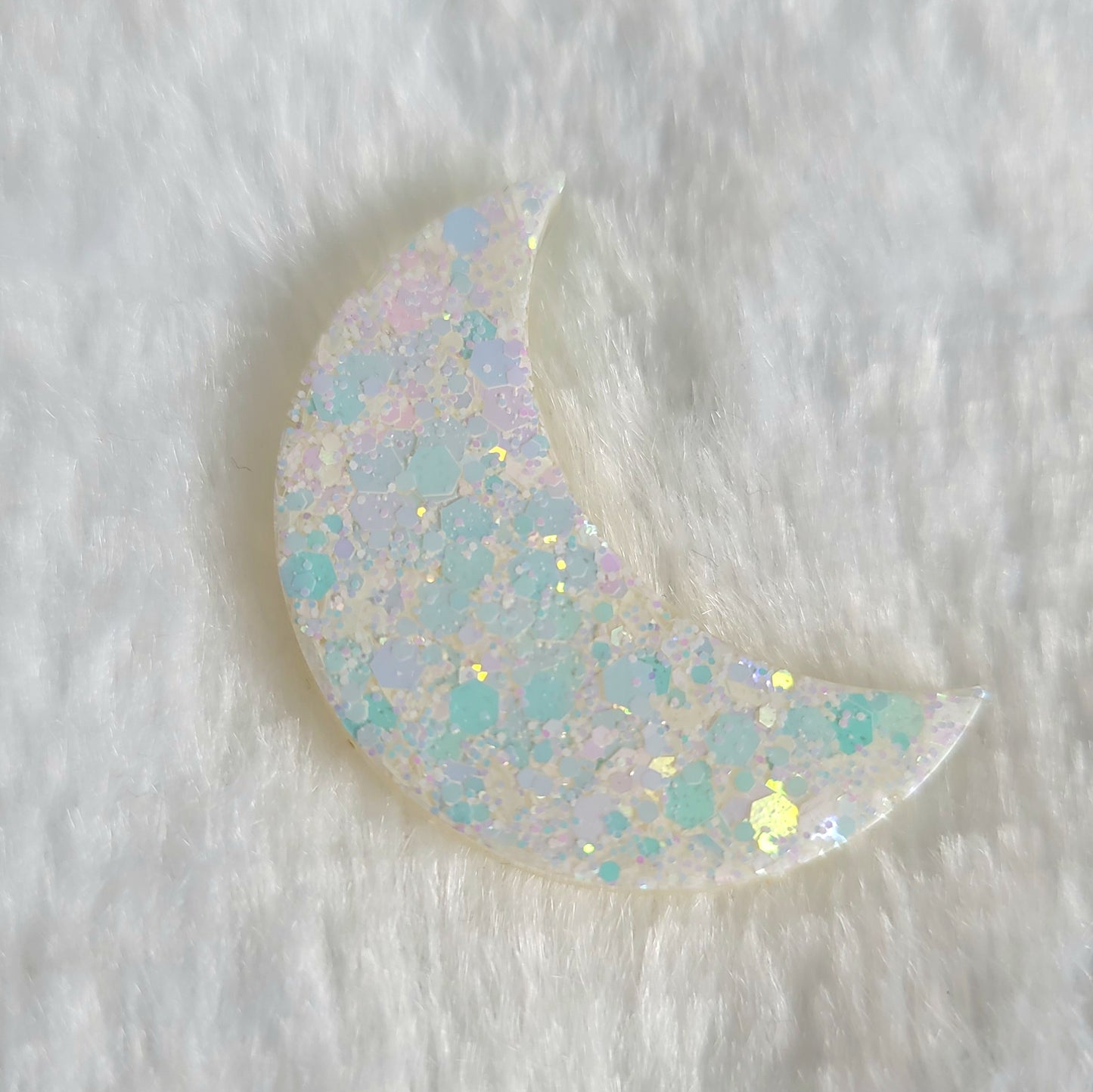 Crescent moon shaped epoxy resin piece, opal white iridescent glitter.