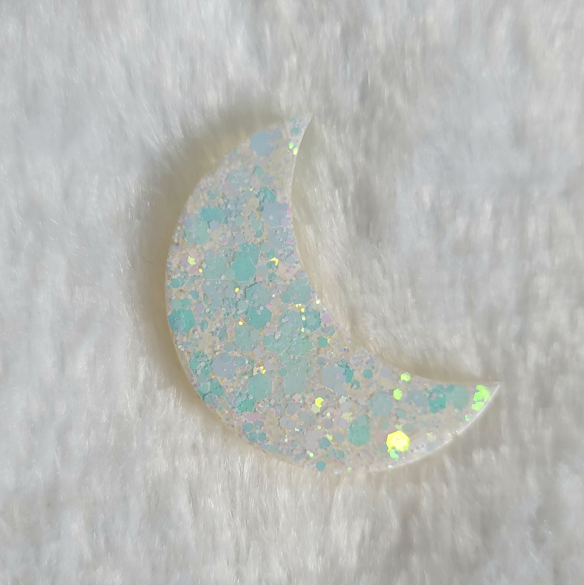 Crescent moon shaped epoxy resin piece, opal white iridescent glitter.