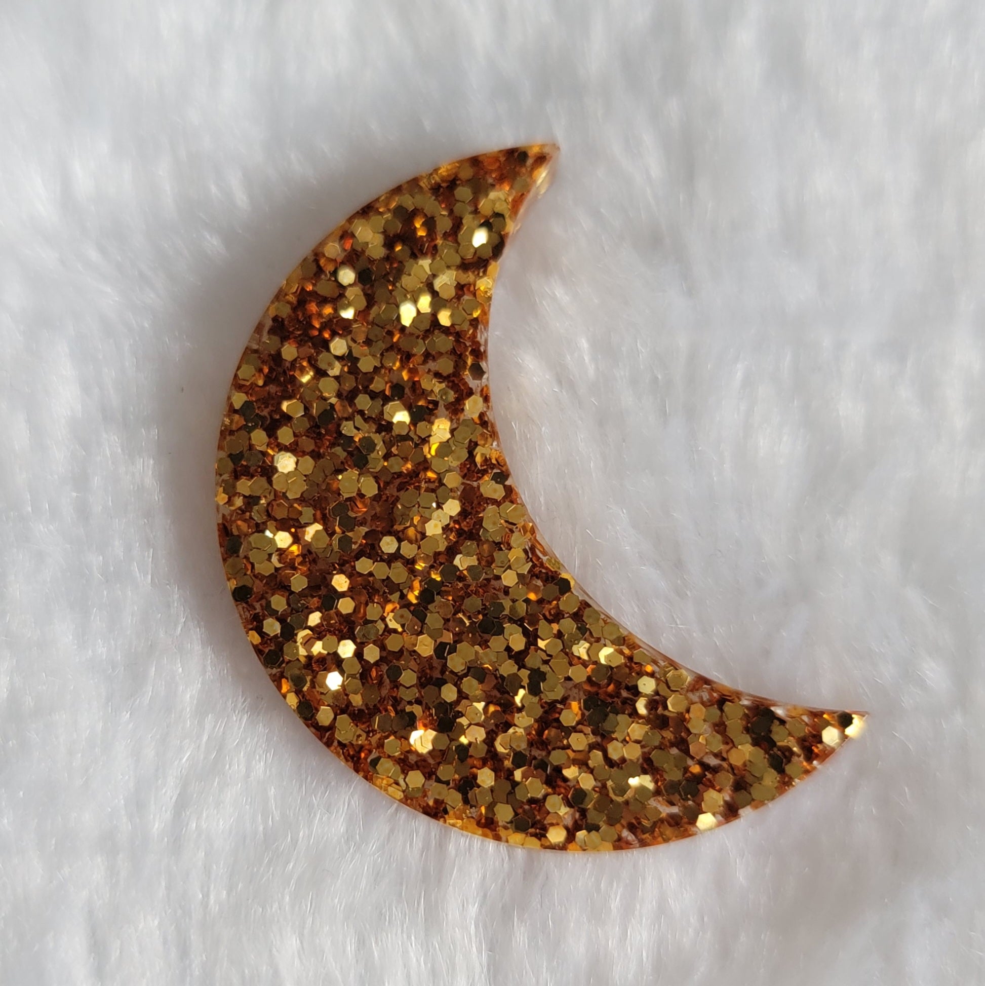 Crescent moon shaped epoxy resin piece, dark gold glitter.