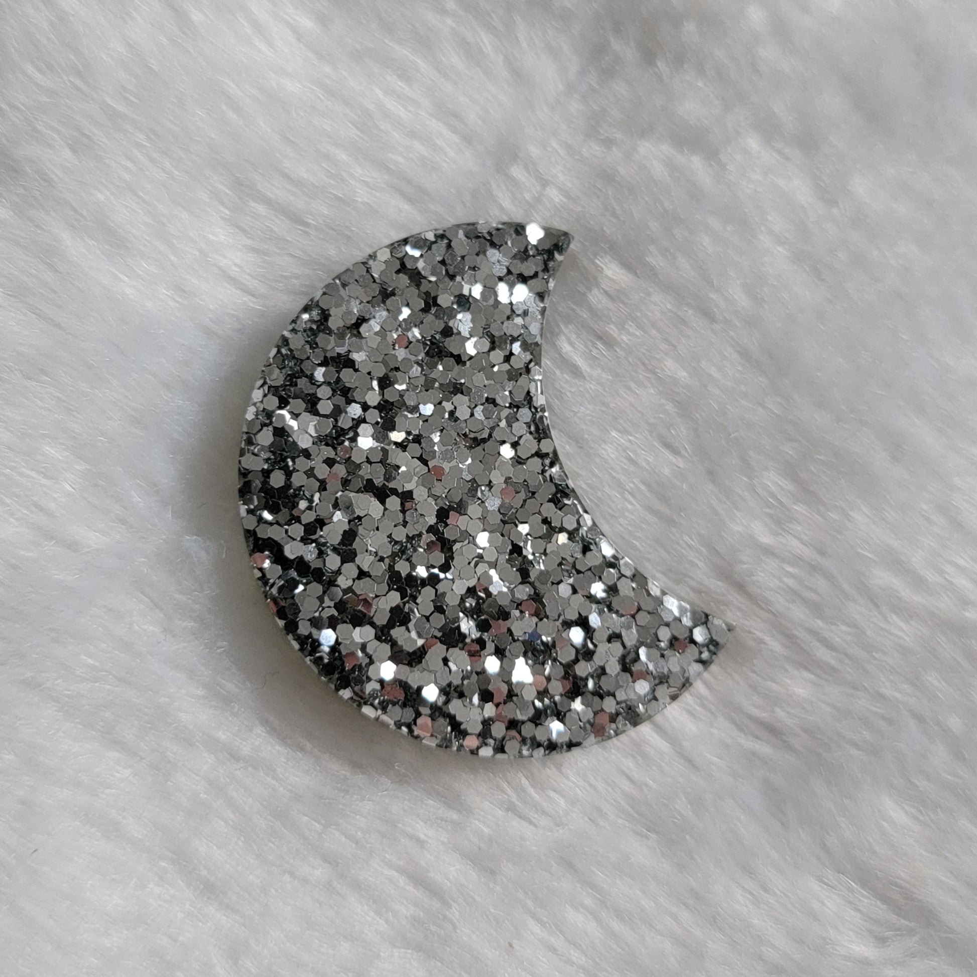 Thick crescent moon shaped epoxy resin piece, bright mercury silver glitter.