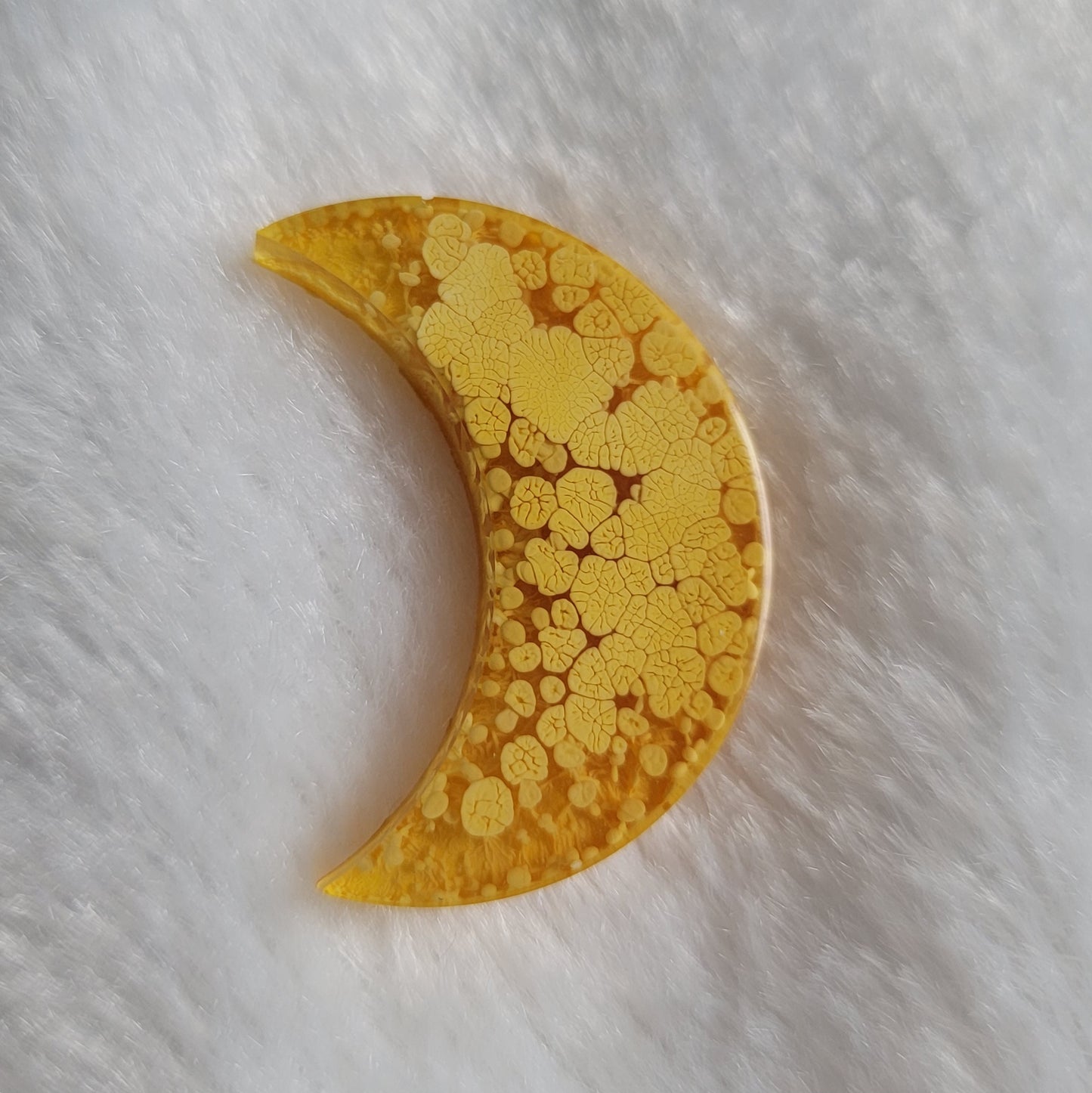 Crescent moon shaped epoxy resin piece, bright mango orange ink drop style.