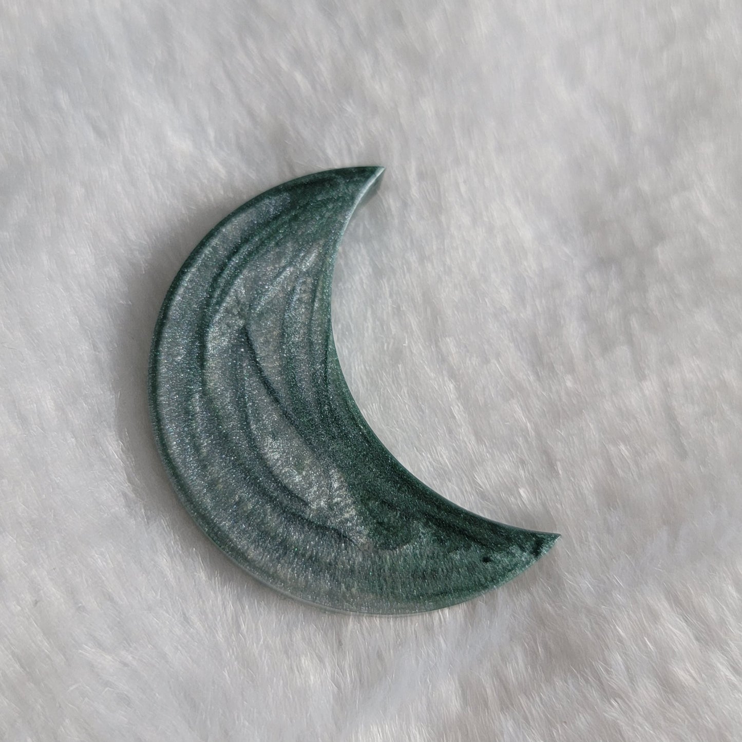 Crescent moon shaped epoxy resin piece, silvery blue swirls.