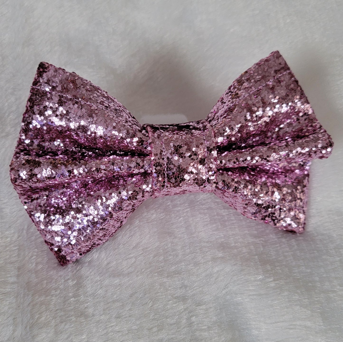 Pet bowtie made from lilac colored glitter canvas.