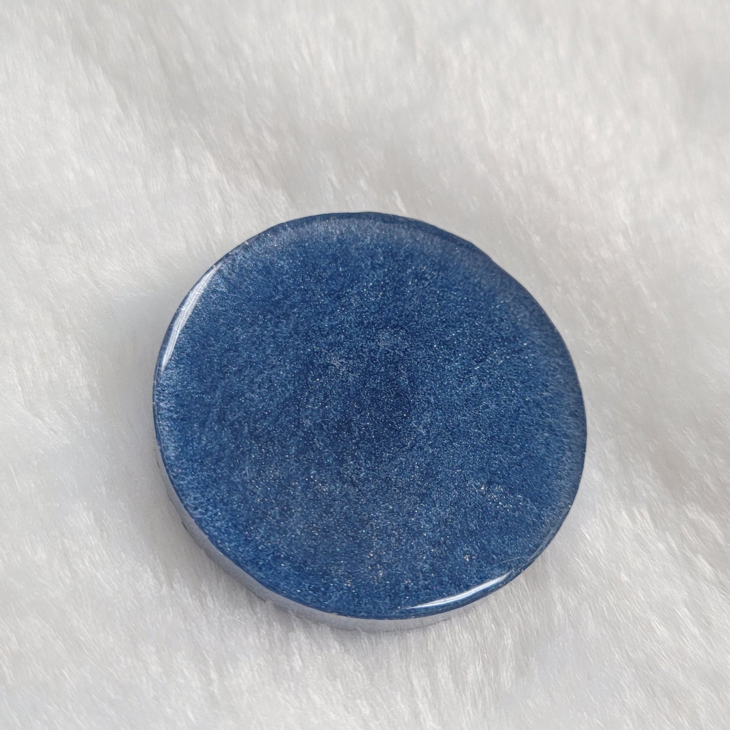 Round epoxy resin piece, light blue back side.