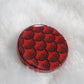 Round epoxy resin piece, deep metallic red fish scales design.