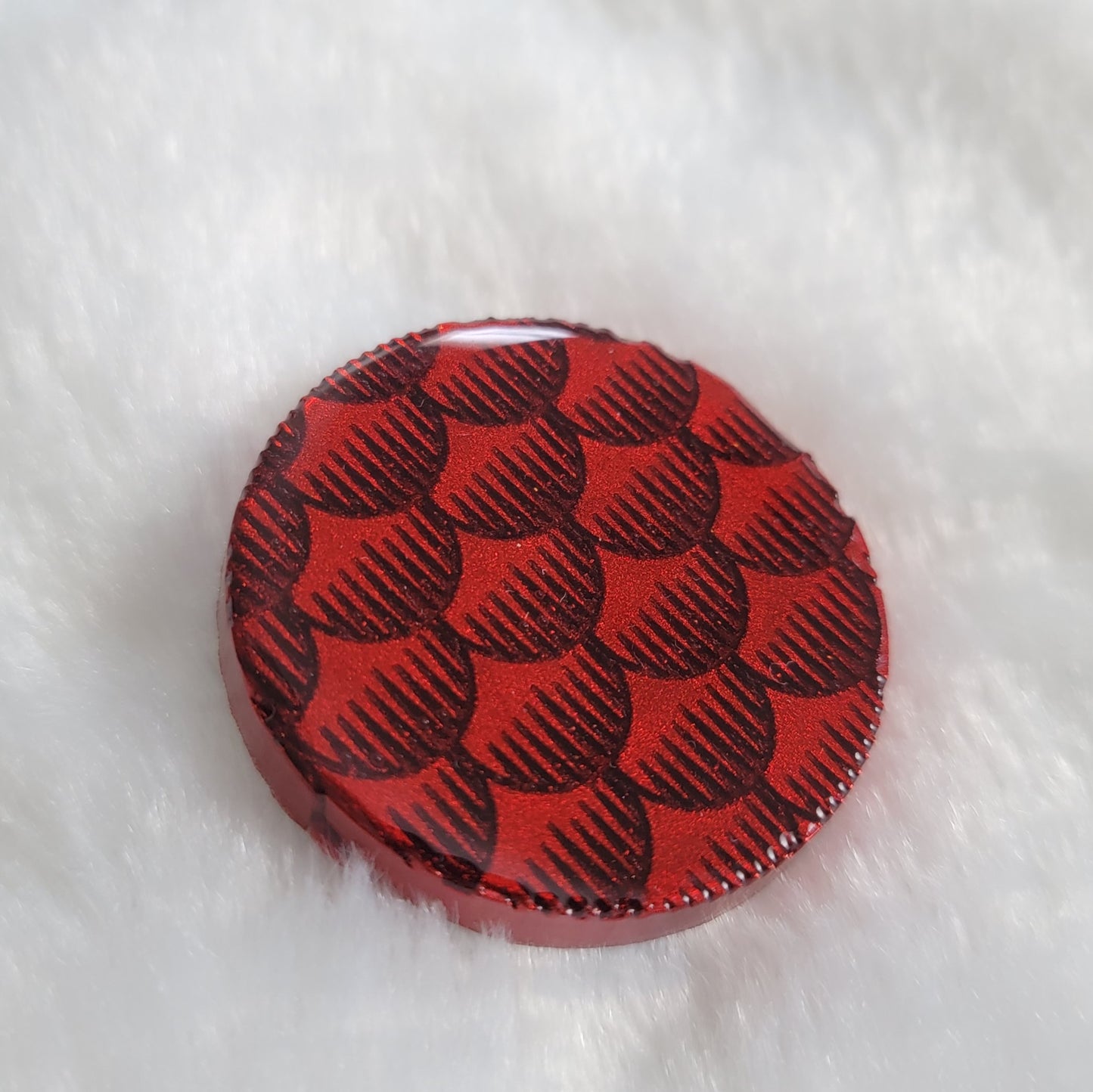 Round epoxy resin piece, deep metallic red fish scales design.