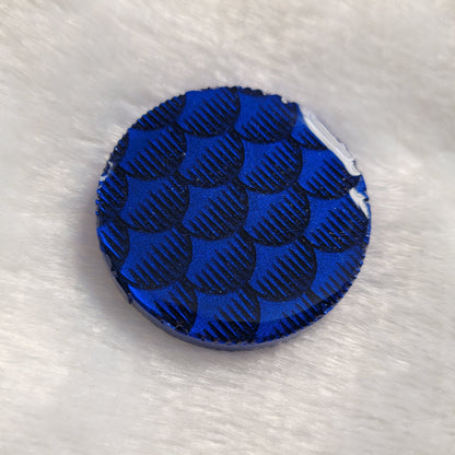 Round epoxy resin piece, dark metallic blue fish scales design.