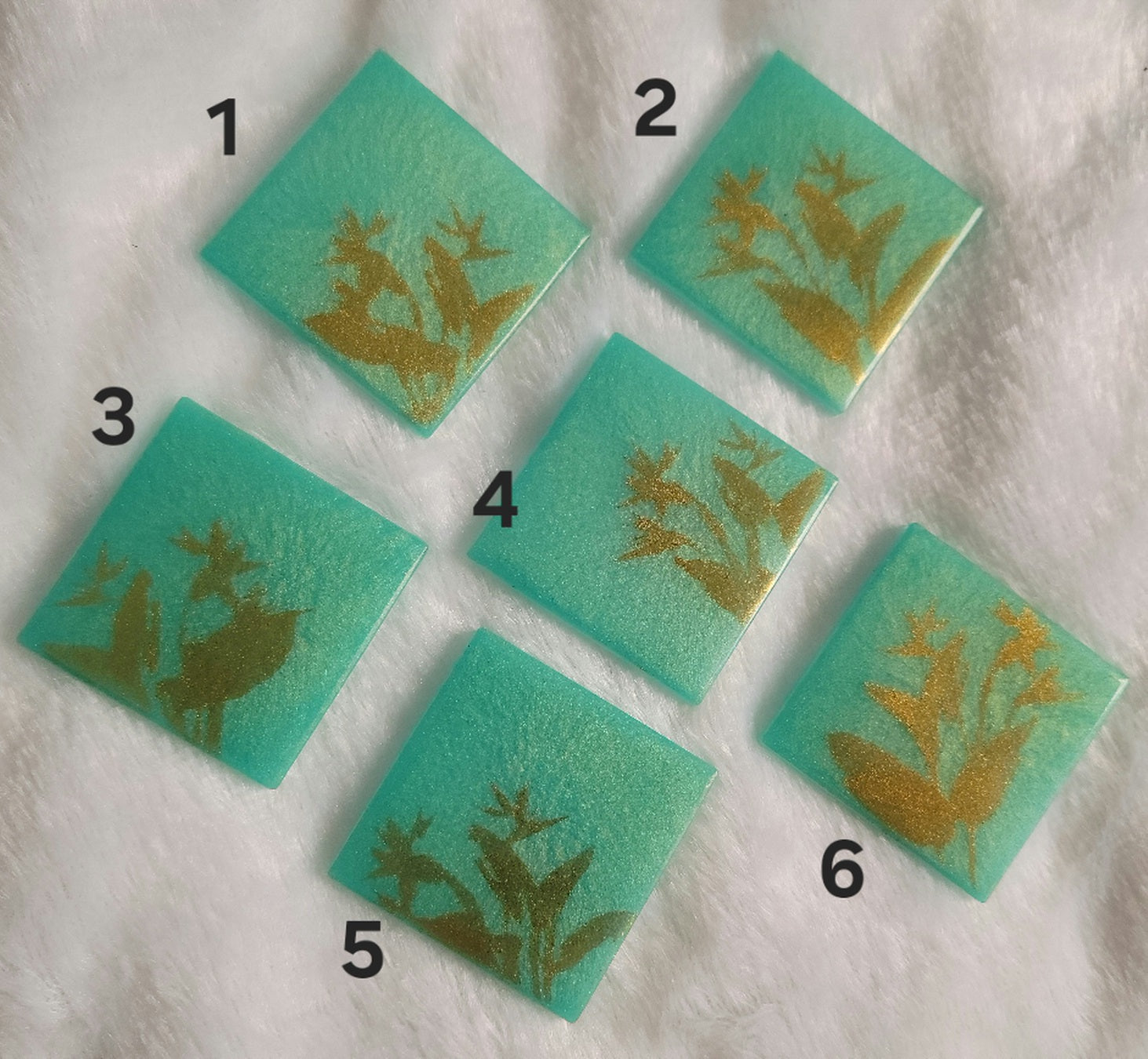 Square epoxy resin pieces, bright aqua green with gold chrome bird of paradise plant design.