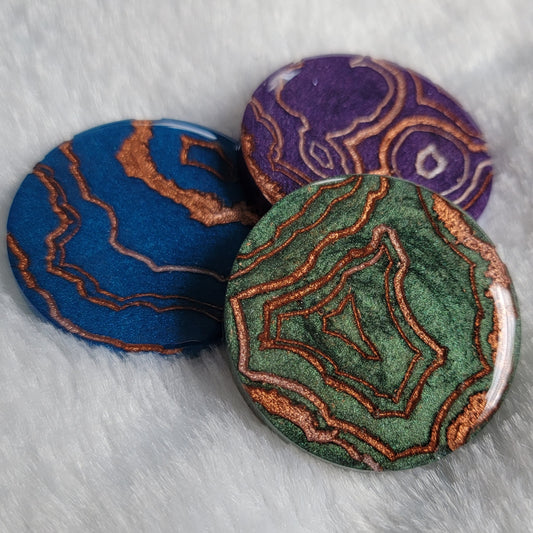 Geode style epoxy resin pieces in green, blue, and purple.