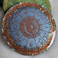 Light blue with glitter epoxy resin coaster with zodiac design details in copper.