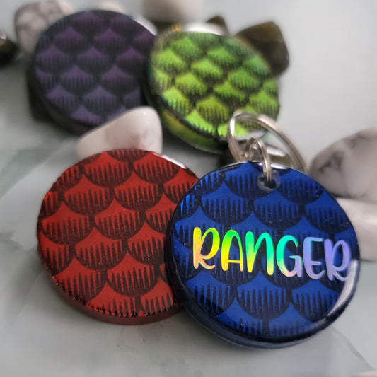 Round epoxy resin pieces with fish scales design in various colors, one shown with personalization.