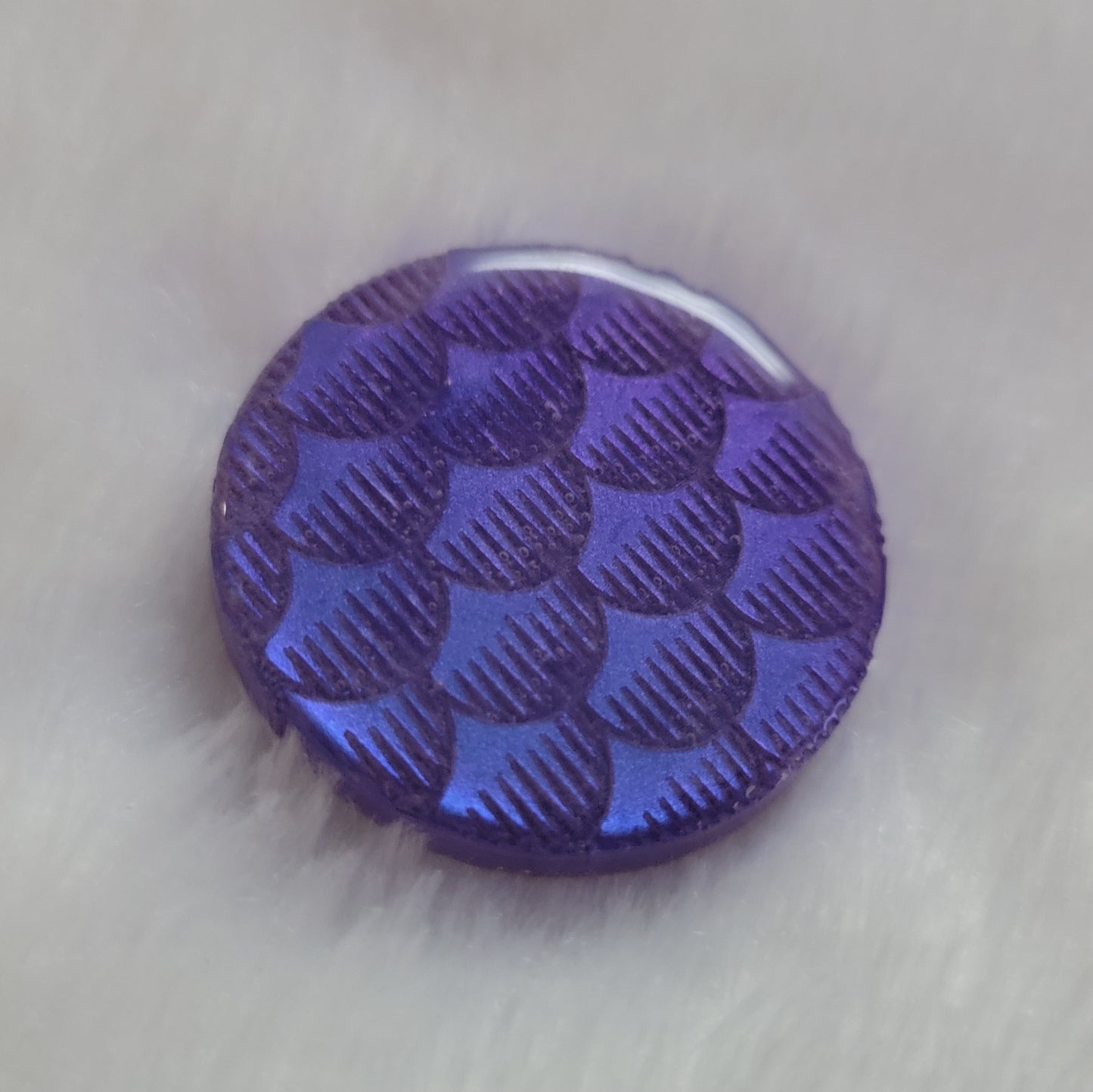 Round epoxy resin piece, violet blue iridescent fish scales design.