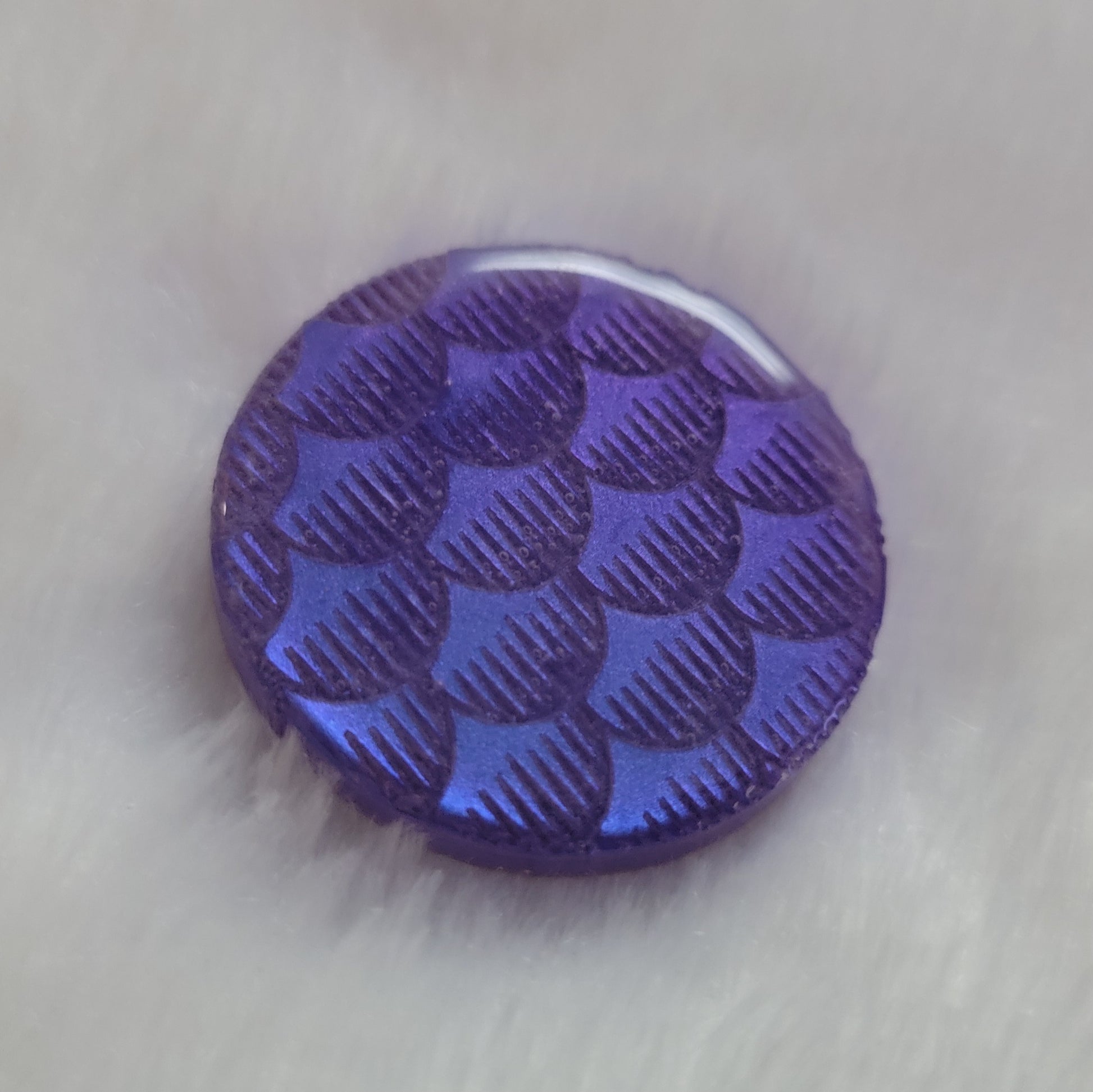 Round epoxy resin piece, violet blue iridescent fish scales design.