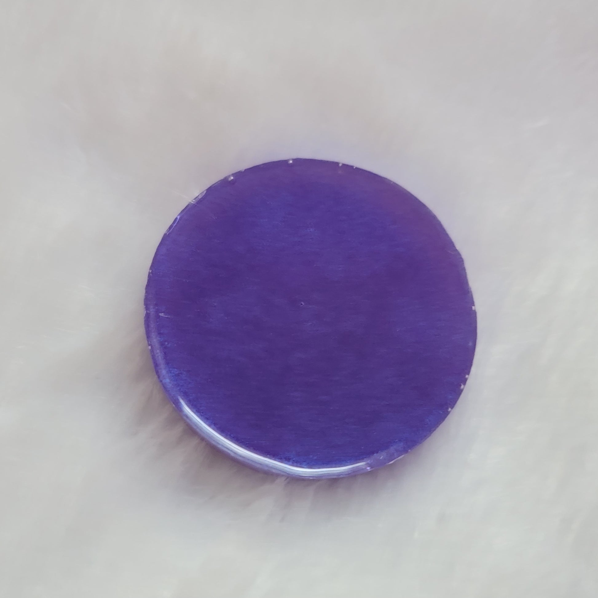 Round epoxy resin piece, bright violet back side.