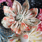 Several fabric flowers with eight petals and fabric covered button center, various springtime prints.