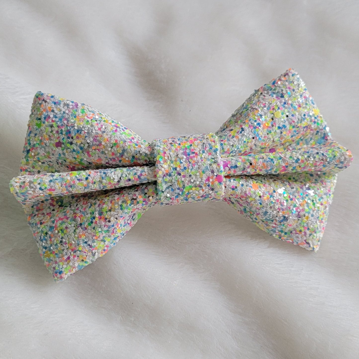 White with neon multicolor glitter canvas bow.