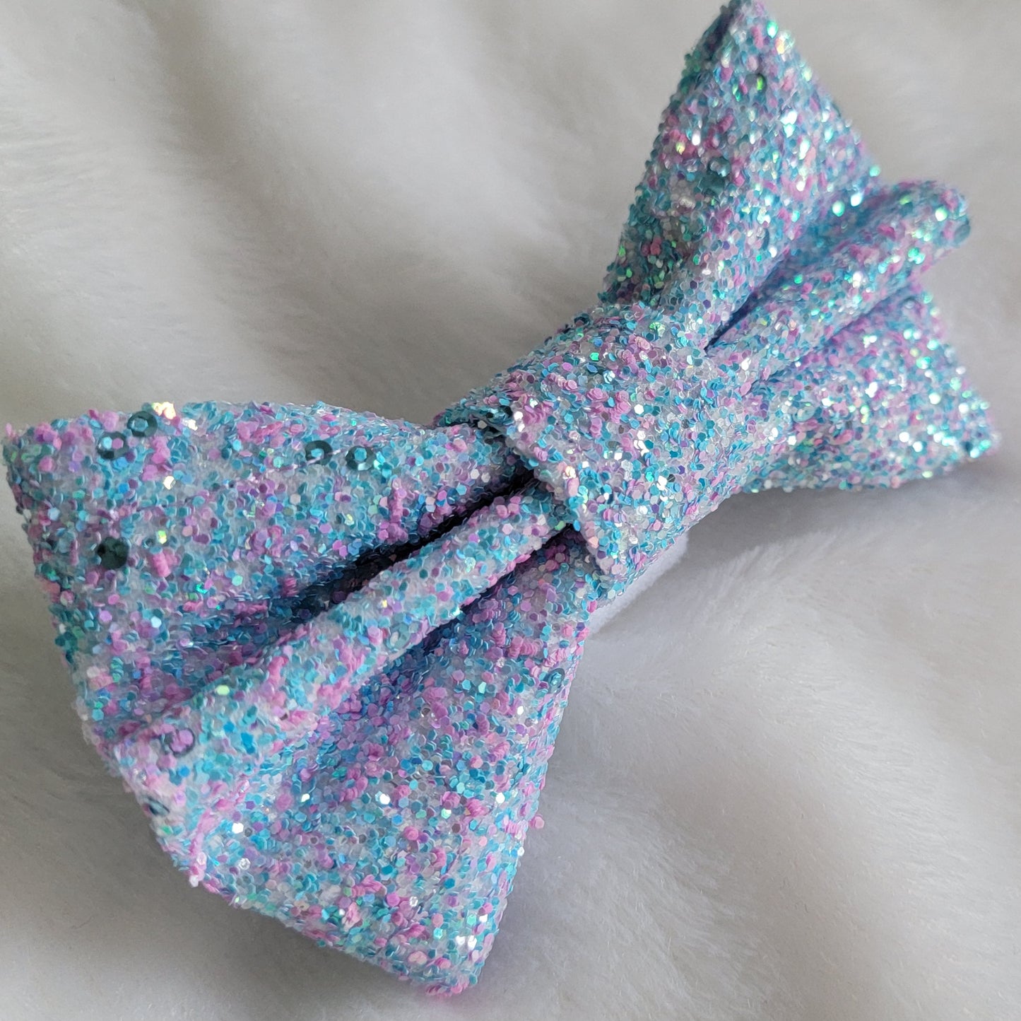 Light blue and pink glitter canvas bow.