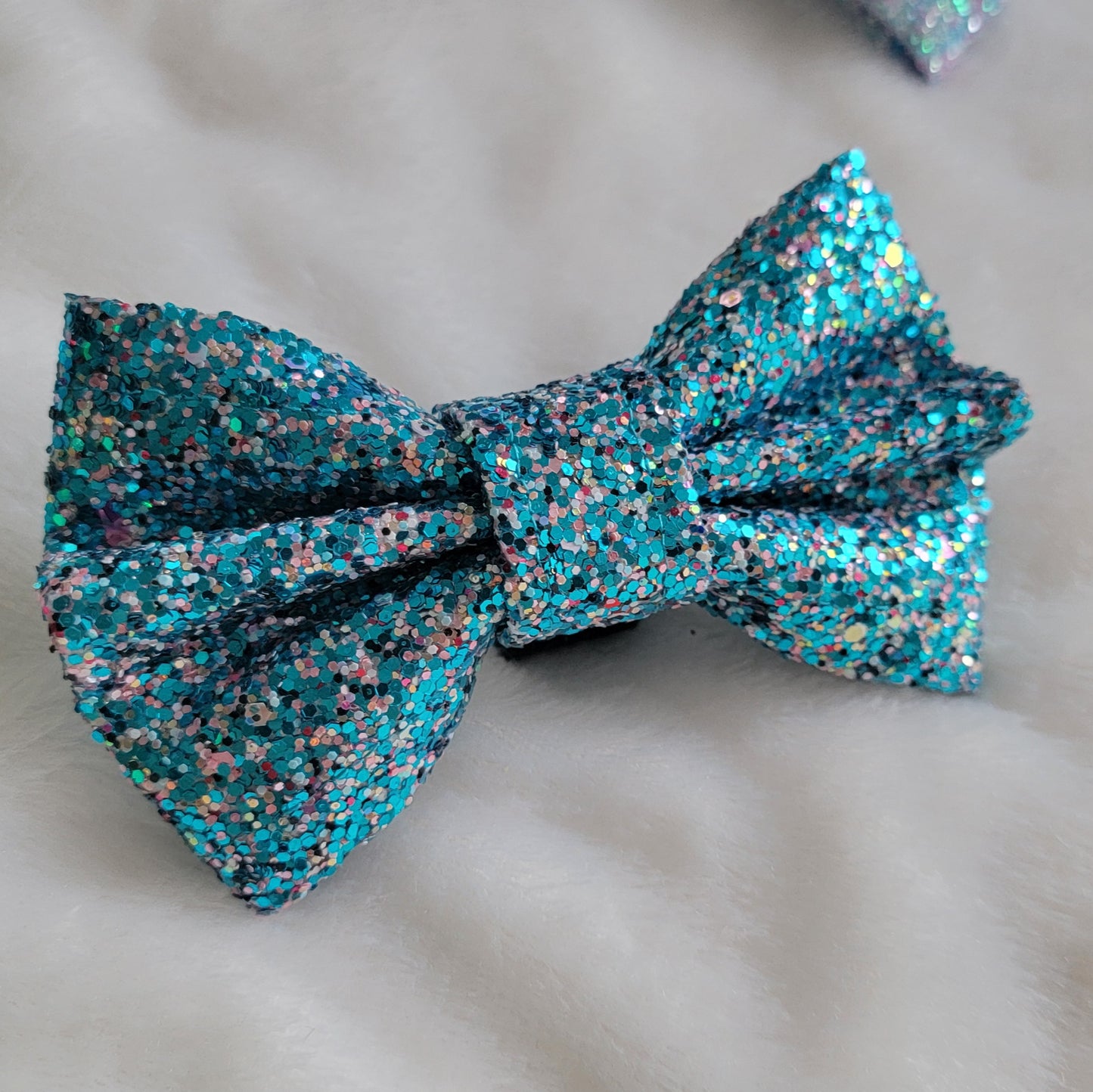 Aqua blue and pink multicolor glitter canvas bow.