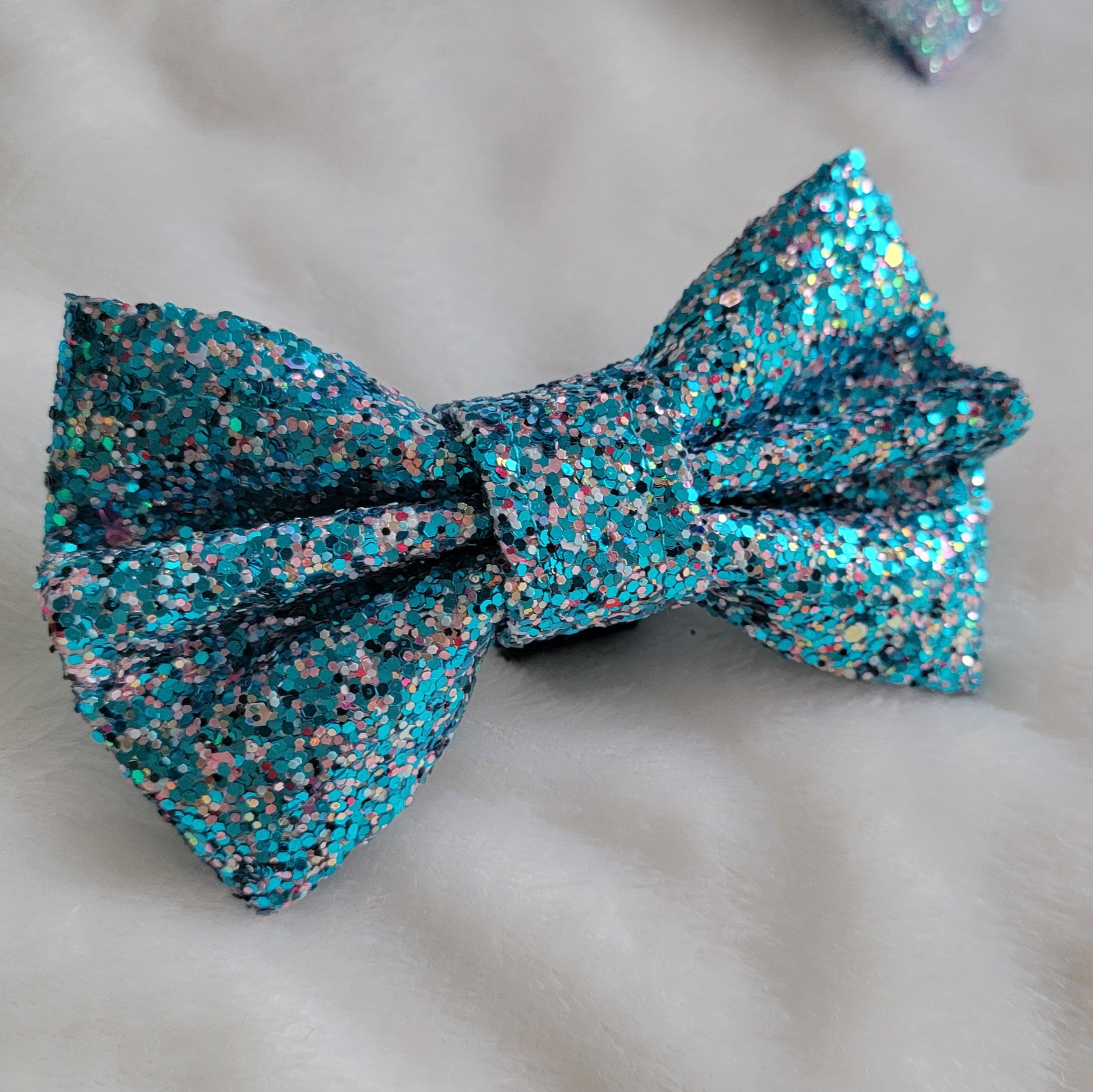 Aqua blue and pink multicolor glitter canvas bow.