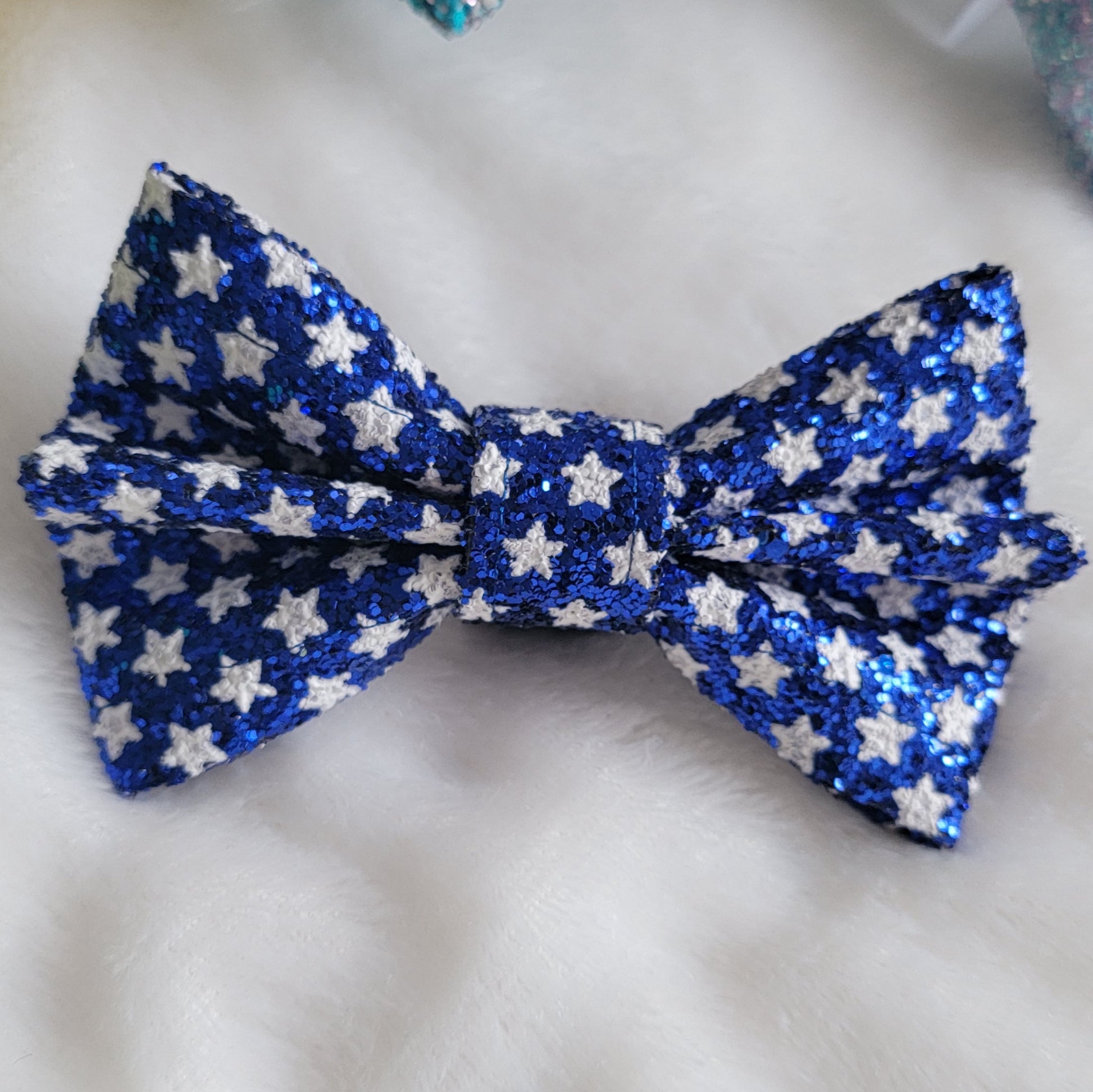 Royal blue with white star print glitter canvas bow.