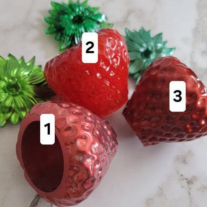 Epoxy resin trinket dishes shaped like strawberries.