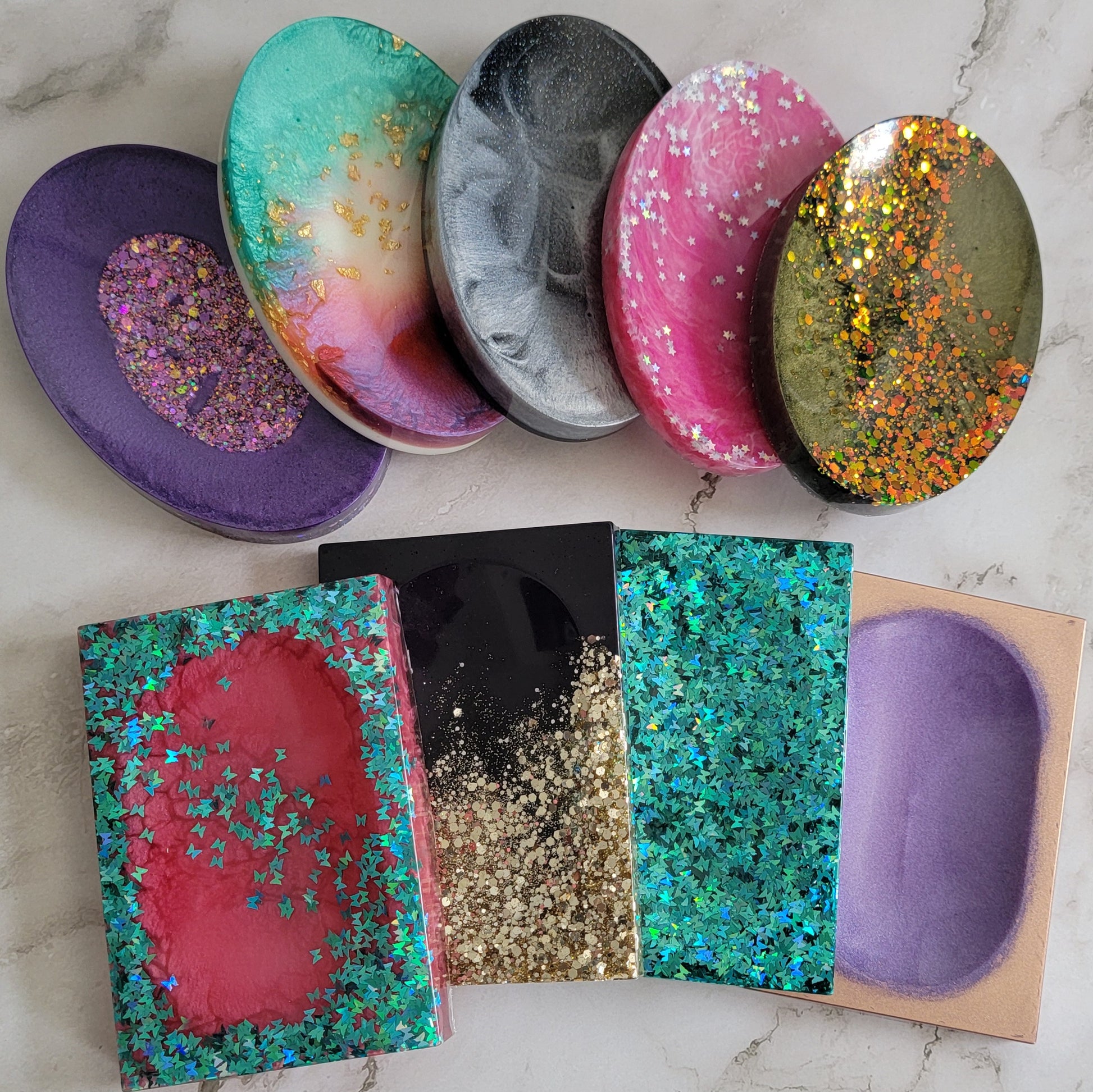 Round and square epoxy resin soap dishes.