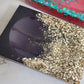 Square epoxy resin soap dish with warm silver glitter on one end fading into deep plum purple.