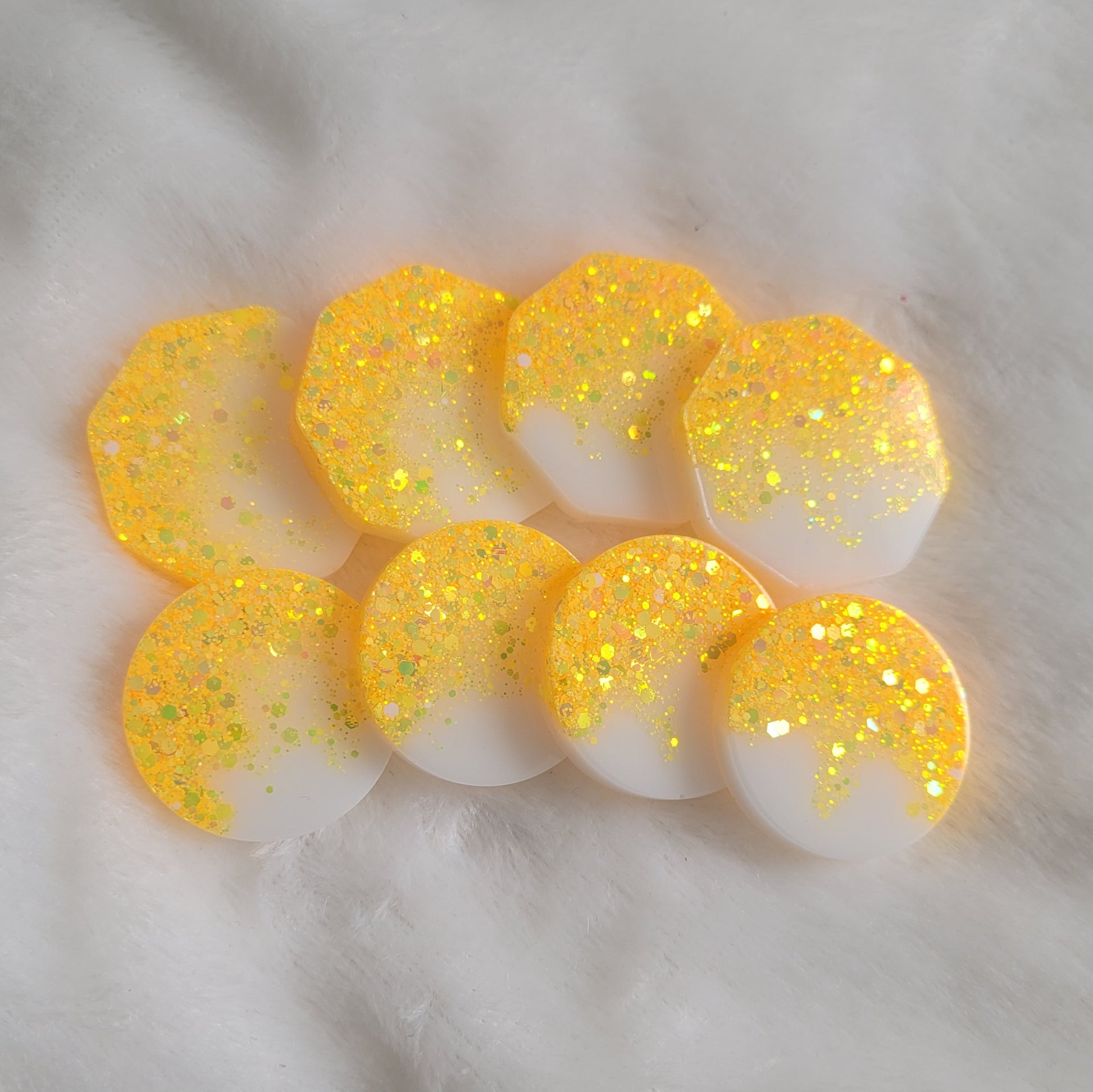 Epoxy resin pieces with ultra bright yellow holographic glitter fading to opaque white pigment.