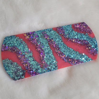 Epoxy resin large rectangular piece in bold stripes of magenta and blue and purple glitter with rounded ends for use as crate tag or decorative sign.