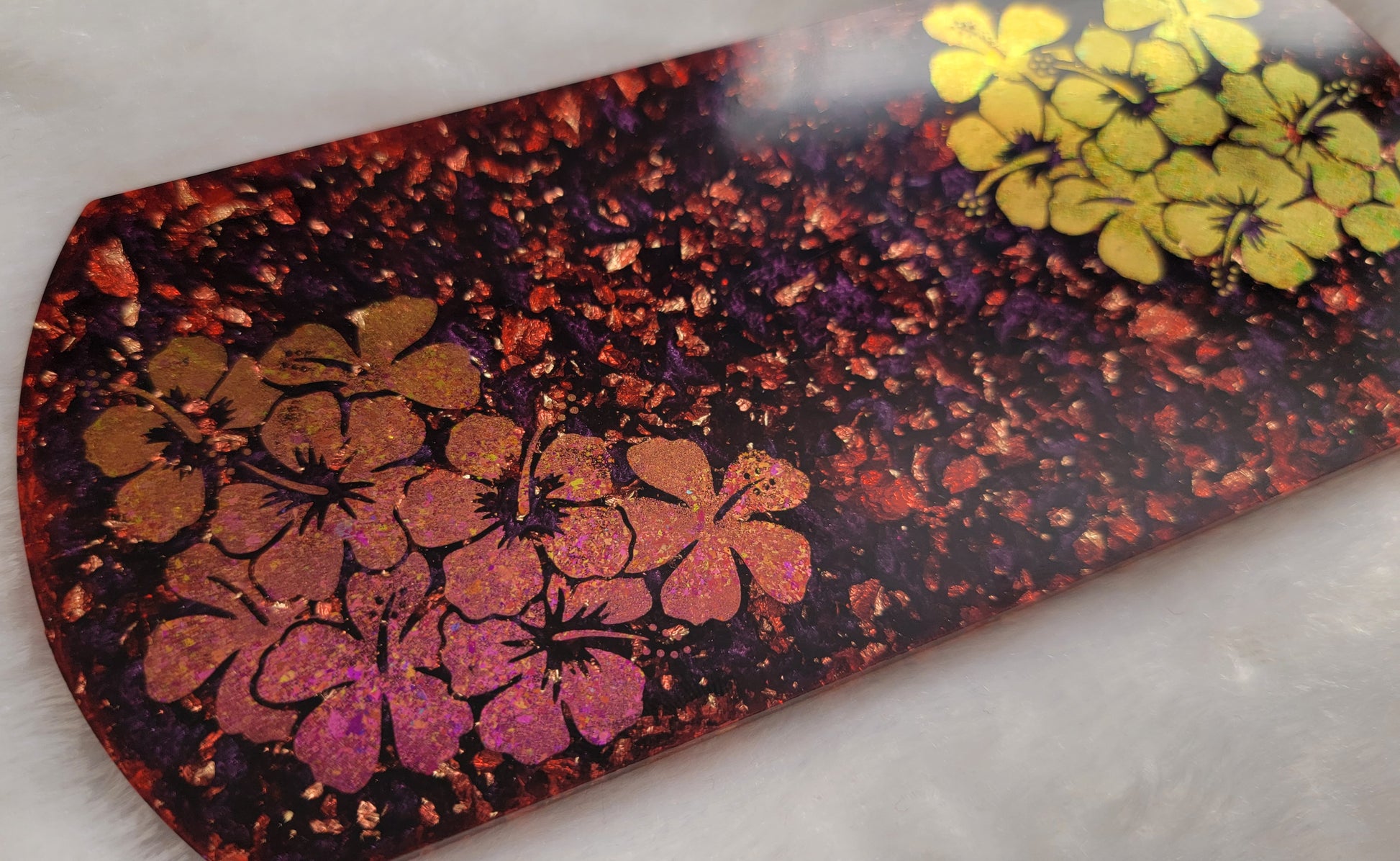 Rectangular epoxy resin piece for crate tag or home decor, rounded ends with deep plum purple and fold flake base and pink/gold hibiscus design.