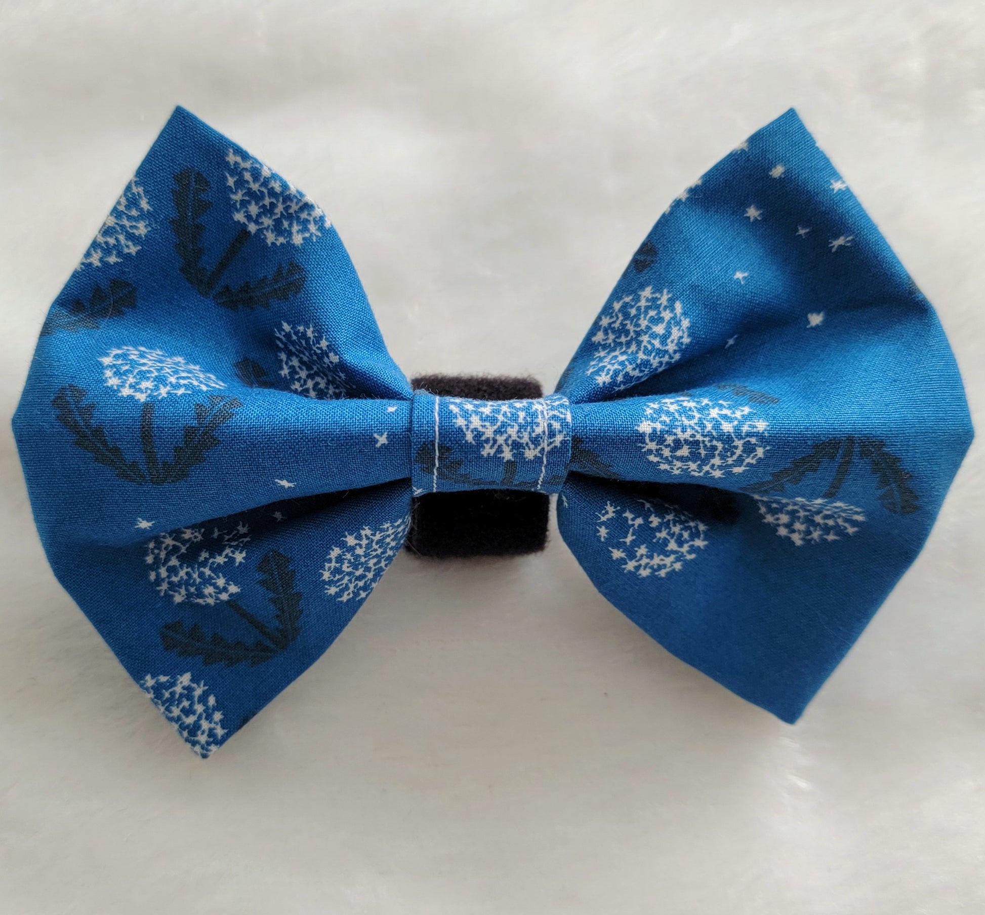 Fabric pet bowtie, deep blue cotton with white and black dandelions print.