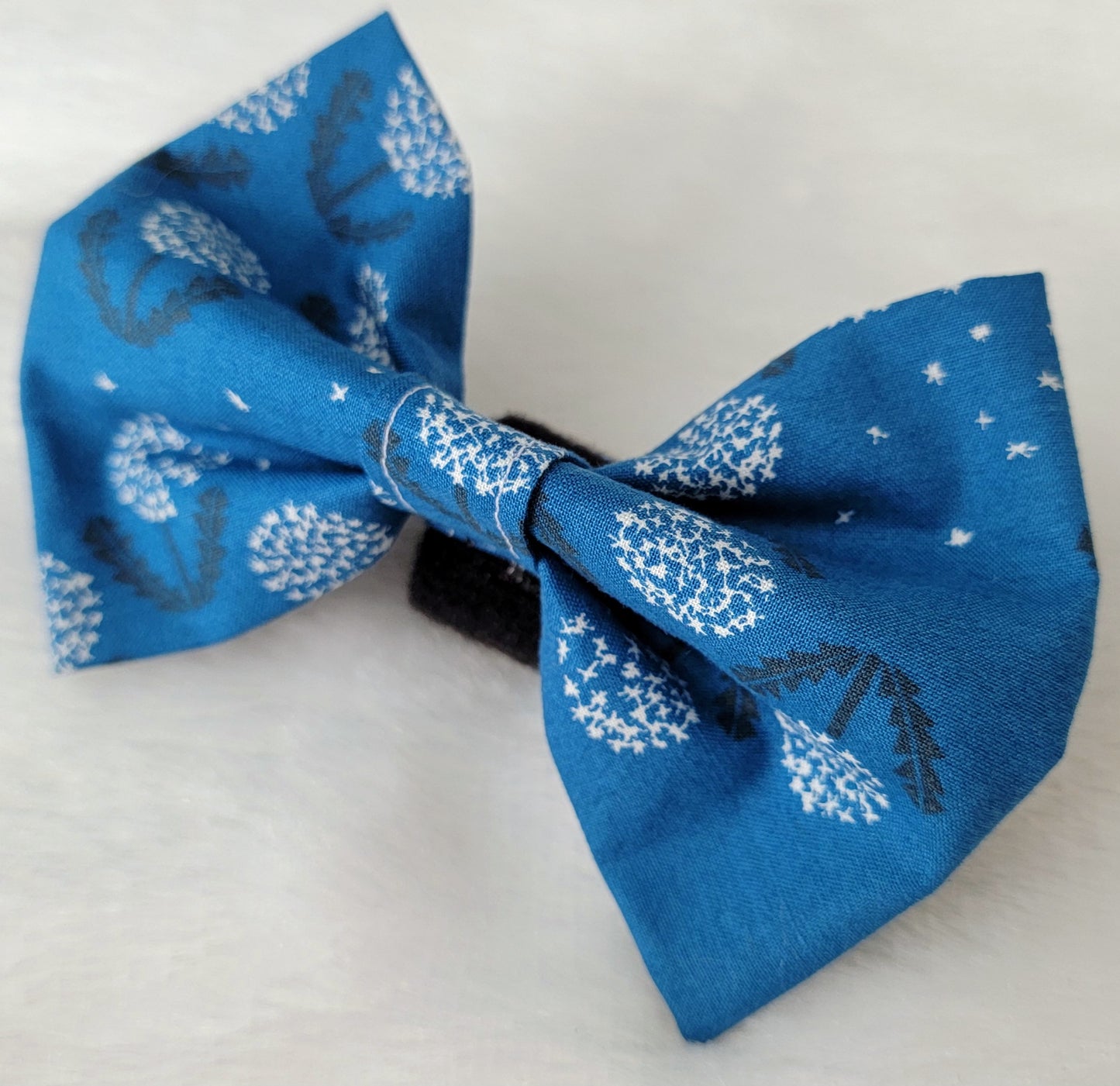 Fabric pet bowtie, deep blue cotton with white and black dandelions print.