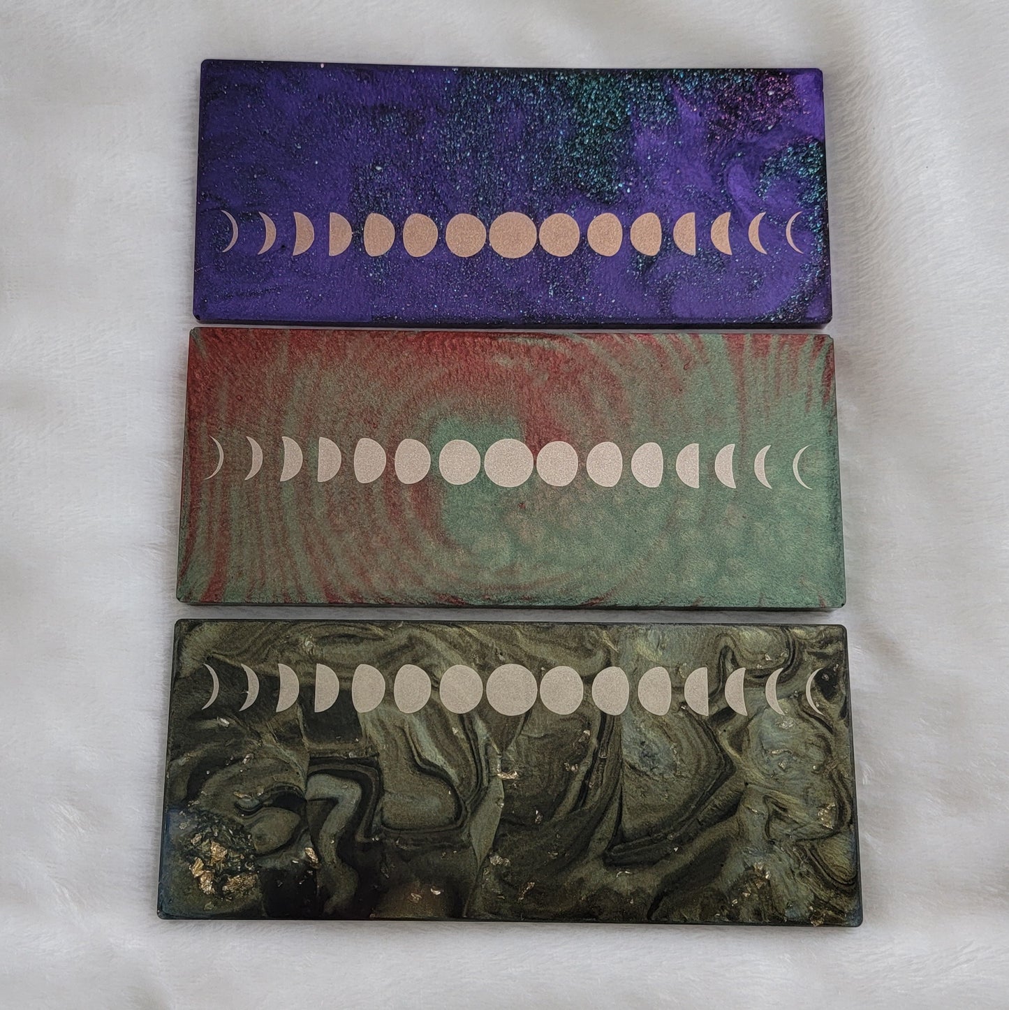 Three rectangular epoxy resin pieces with metallic moon phases motif.